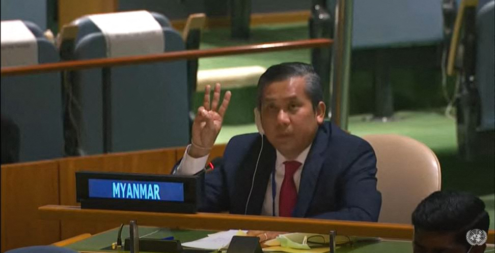 Diplomat Moe Kyaw Tun making the three fingered salute of Myanmar's anti-coup movement at a UN meeting five days after the military seized power. He is sitting at the Myanmar desk in the UN General Assembly
