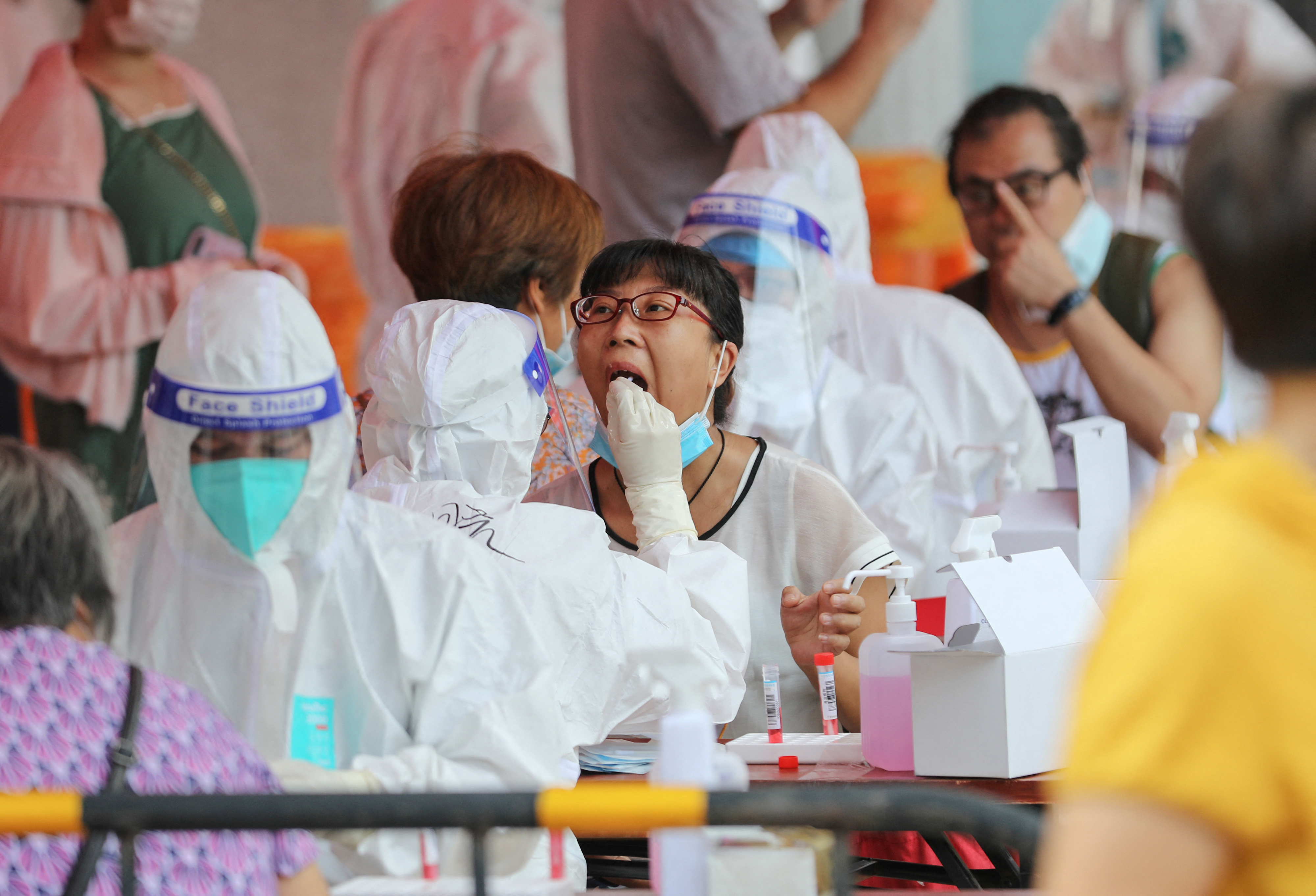 A resident undergoes a nucleic acid test for the COVID-19 coronavirus in Xiamen, in China's eastern Fujian province on September 14 [Stringer/AFP]