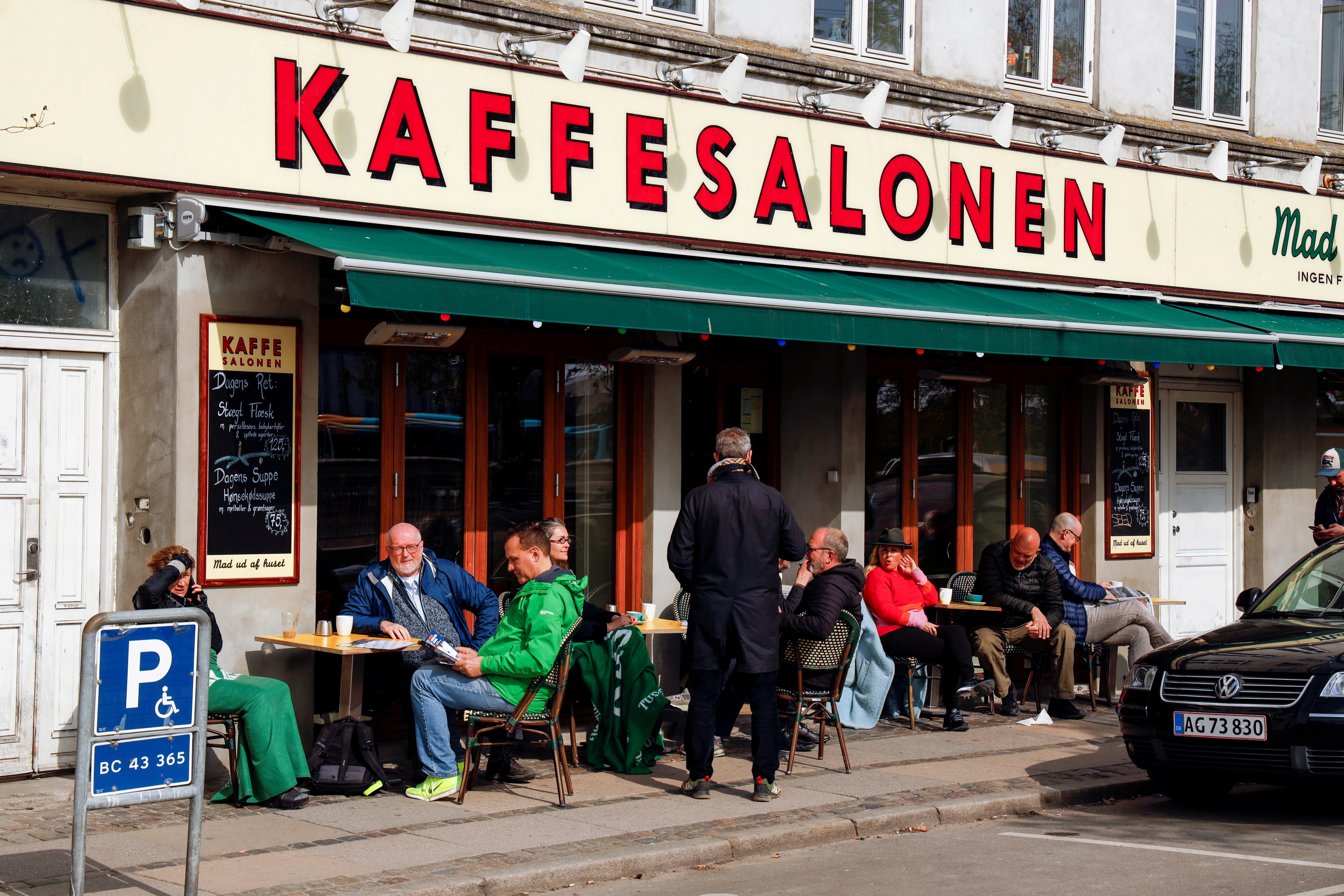 People sit at Kaffesalonen (The Coffee Saloon) as COVID-19 restrictions ease, in central Copenhagen, Denmark