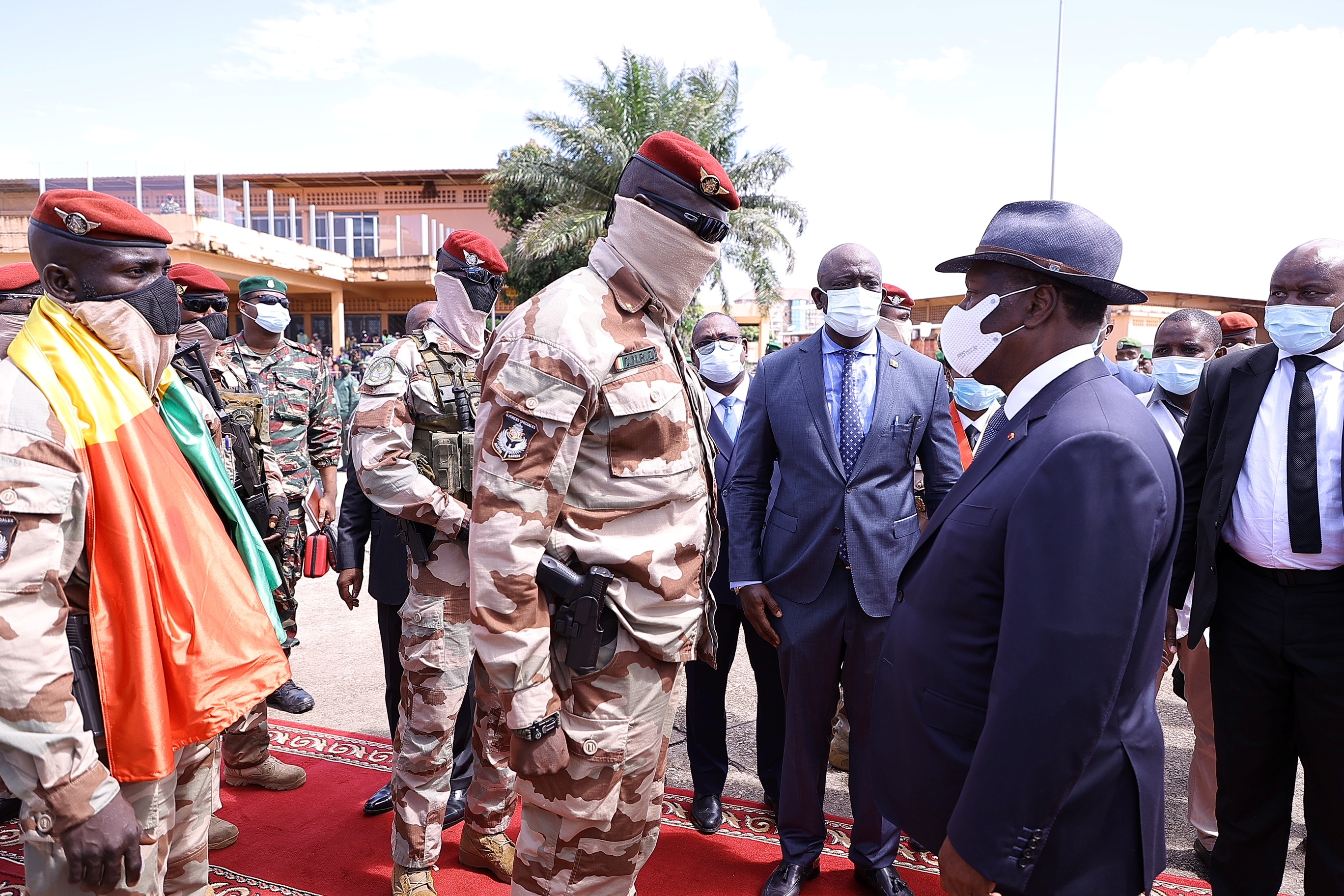 Colonel Mamady Doumbouya, left, who deposed President Alpha Conde earlier in September, greets Ivory Coast's President Alassane Ouattara, right [File: Ivory Coast Presidency/Reuters]