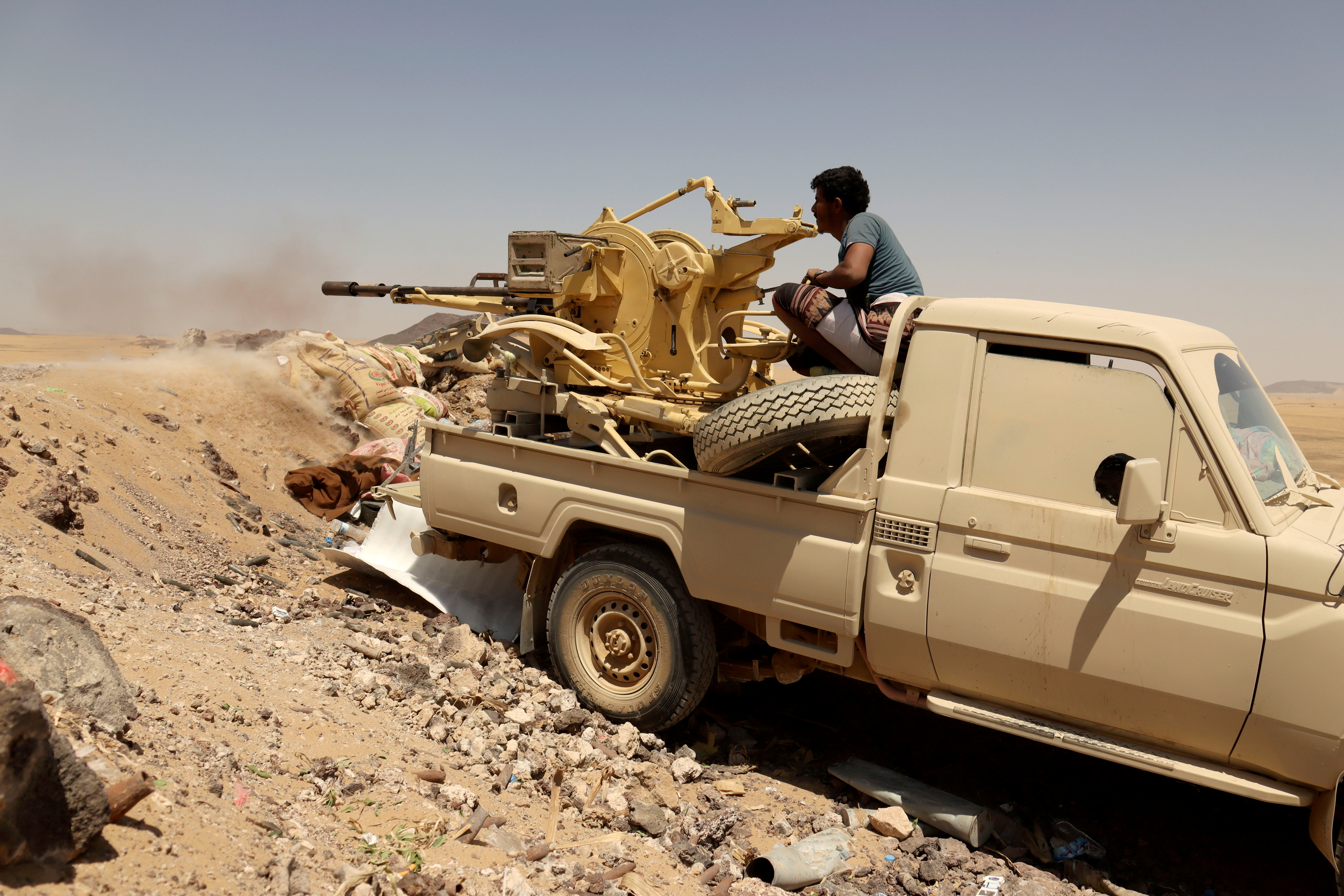 FILE PHOTO: A Yemeni government fighter fires a vehicle-mounted weapon at a frontline position during fighting against Houthi fighters in Marib, Yemen March 28, 2021.