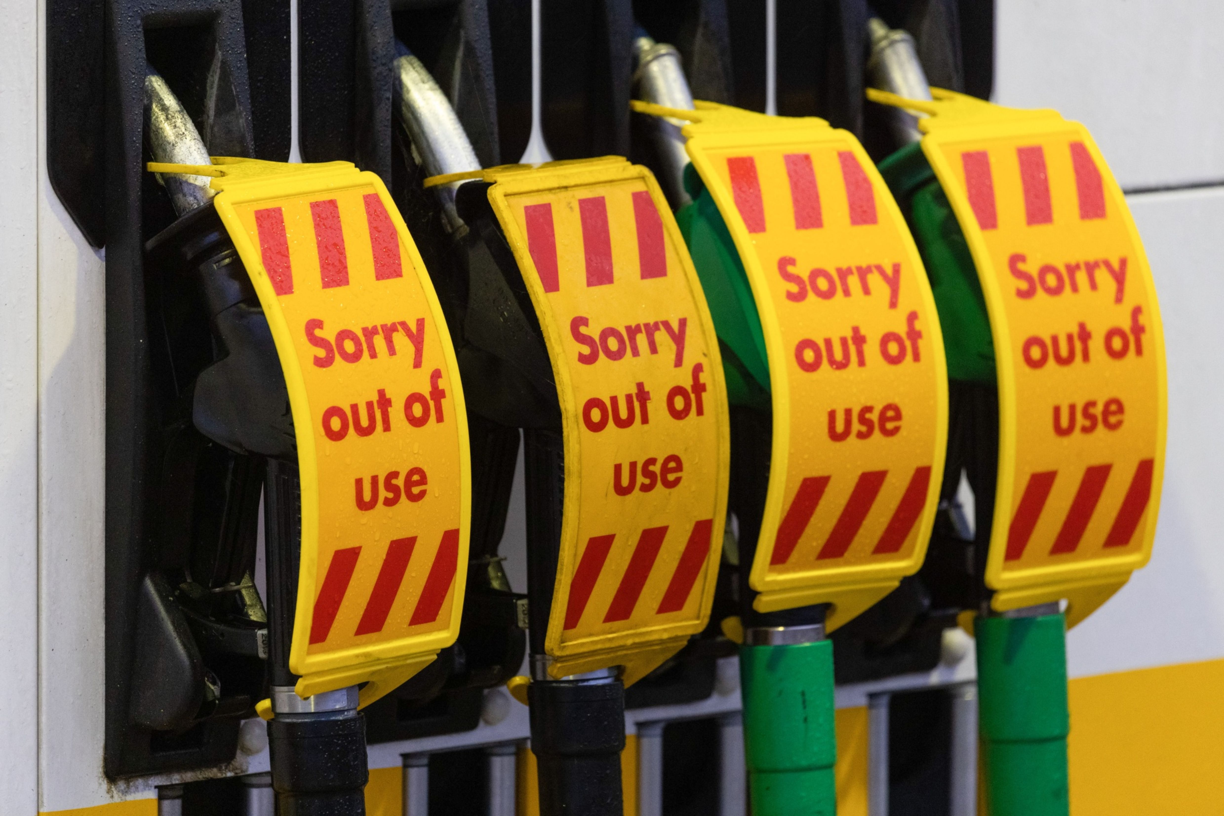 'Sorry out of use' signs have become ubiquitous at petrol stations in many parts of the United Kingdom as energy firms fold and panic buyers make a run on dwindling fuel supplies [File: Jason Alden/Bloomberg]