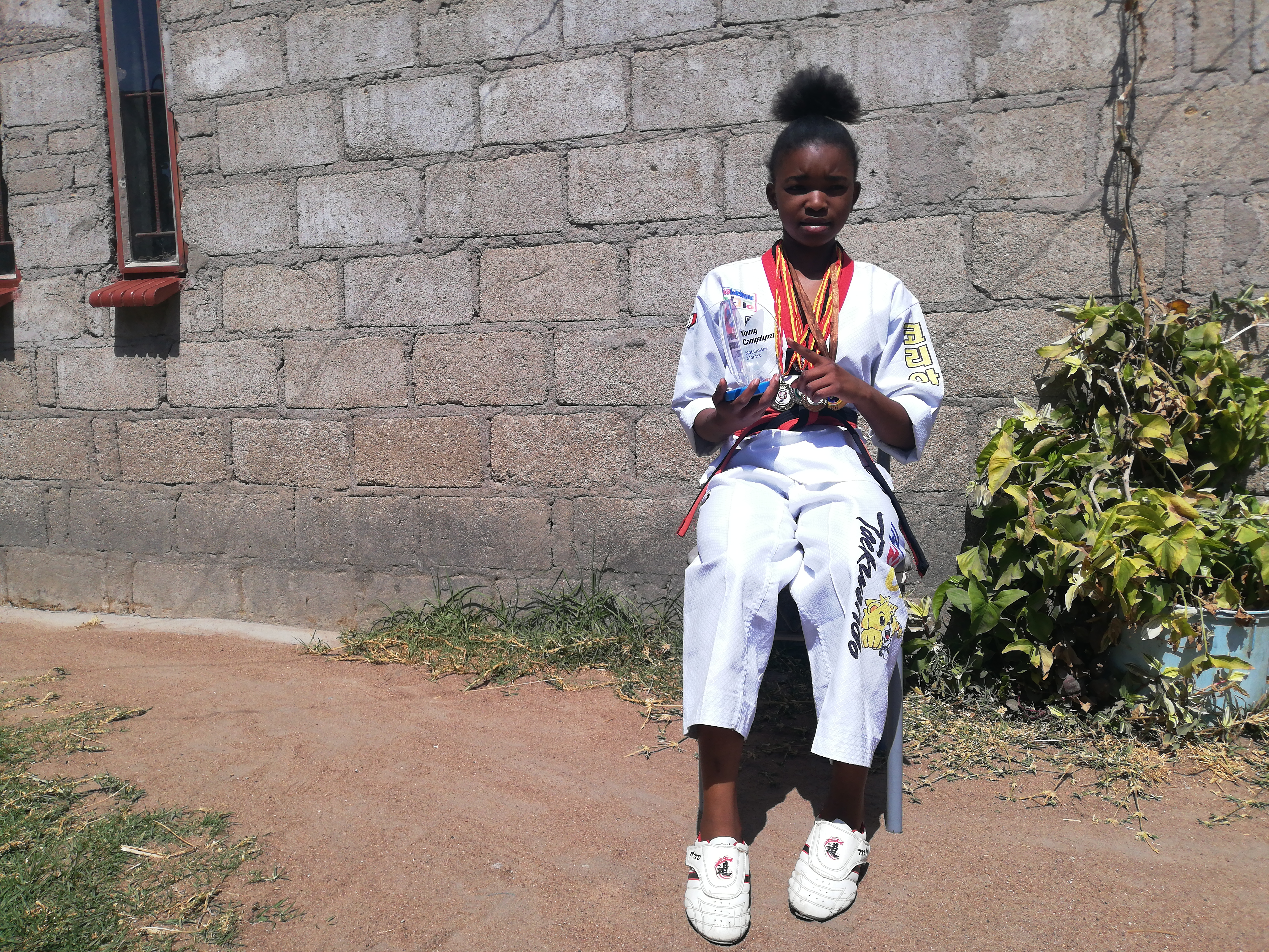 Natsiraishe Maritsa from Epworth has won several awards in taekwondo tournaments and for her work supporting girls [Farai Matiashe/Al Jazeera]
