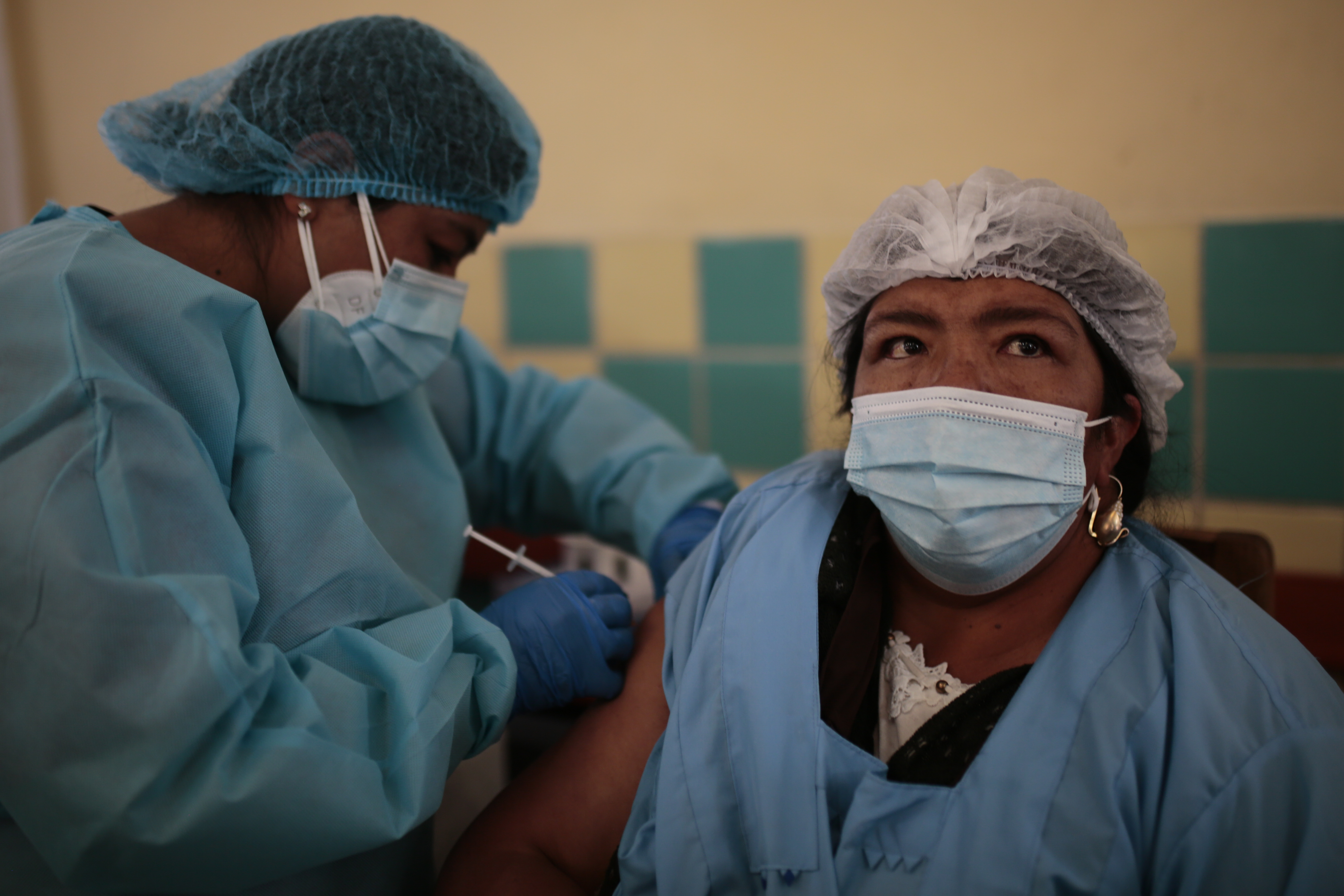 A health worker applies a dose of vaccine as part of the vaccination campaign against COVID-19 at Rodriguez wholesale market on August 25, 2021, in La Paz, Bolivia [File: Gaston Brito/Getty Images]