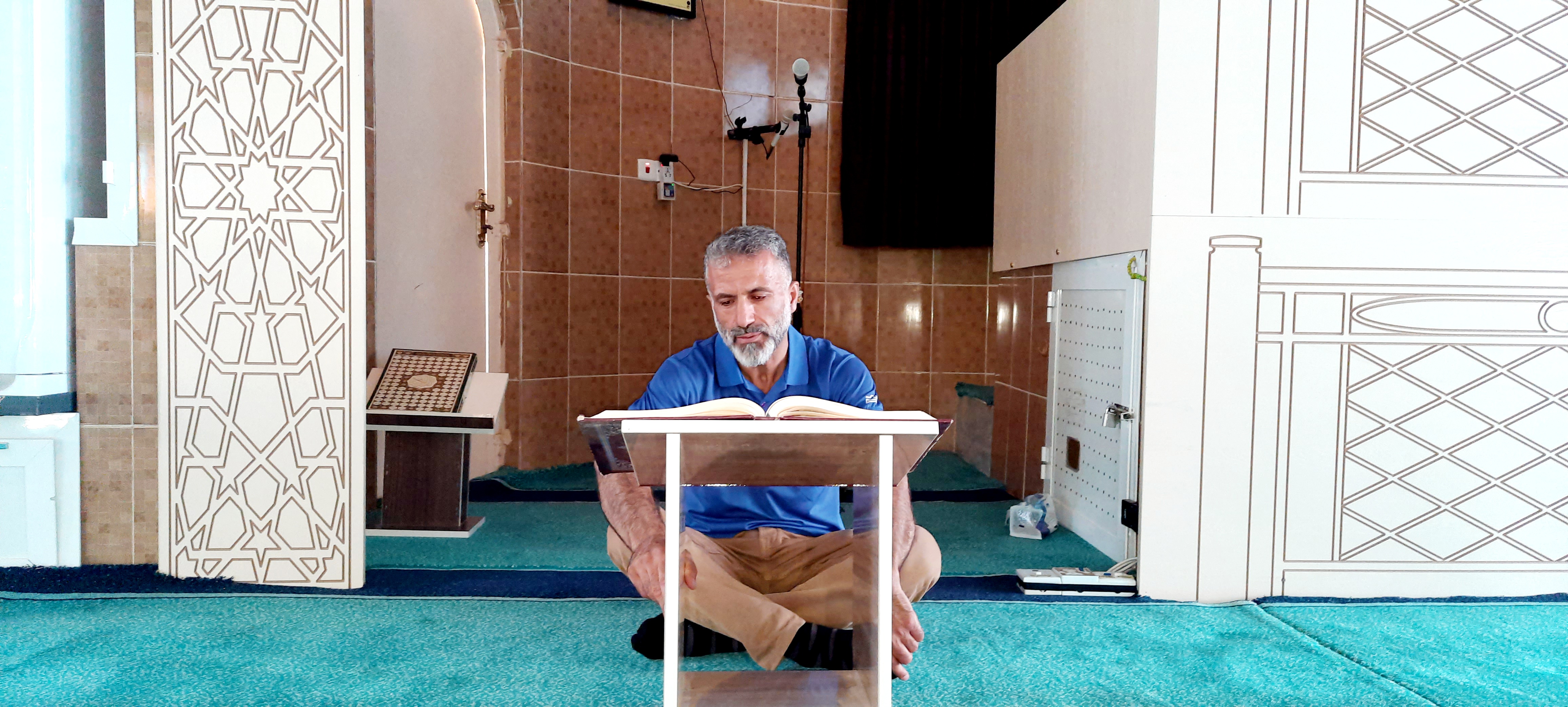 Aref recites the Quran at his mosque in the Kurdish region of northern Iraq [Dana Taib Menmy/Al Jazeera]