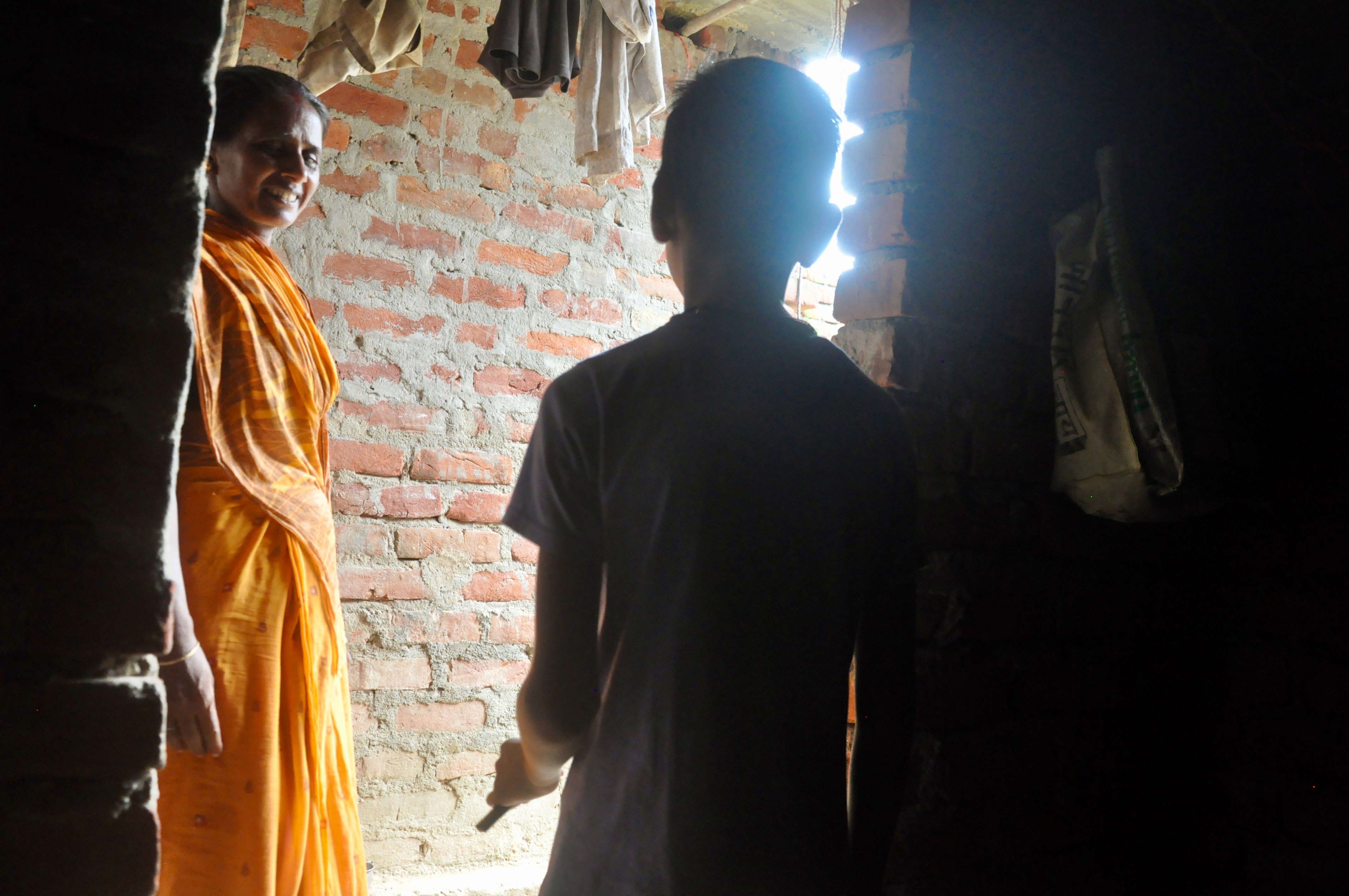 Rajesh Sah, right, at his home in Kharauna village, in Gaya district's Atri block in Bihar. Rajesh, 10, escaped by running for 20 minutes, barefoot, to a police outpost near the factory where he worked for about a year [Kavitha Iyer/Al Jazeera]