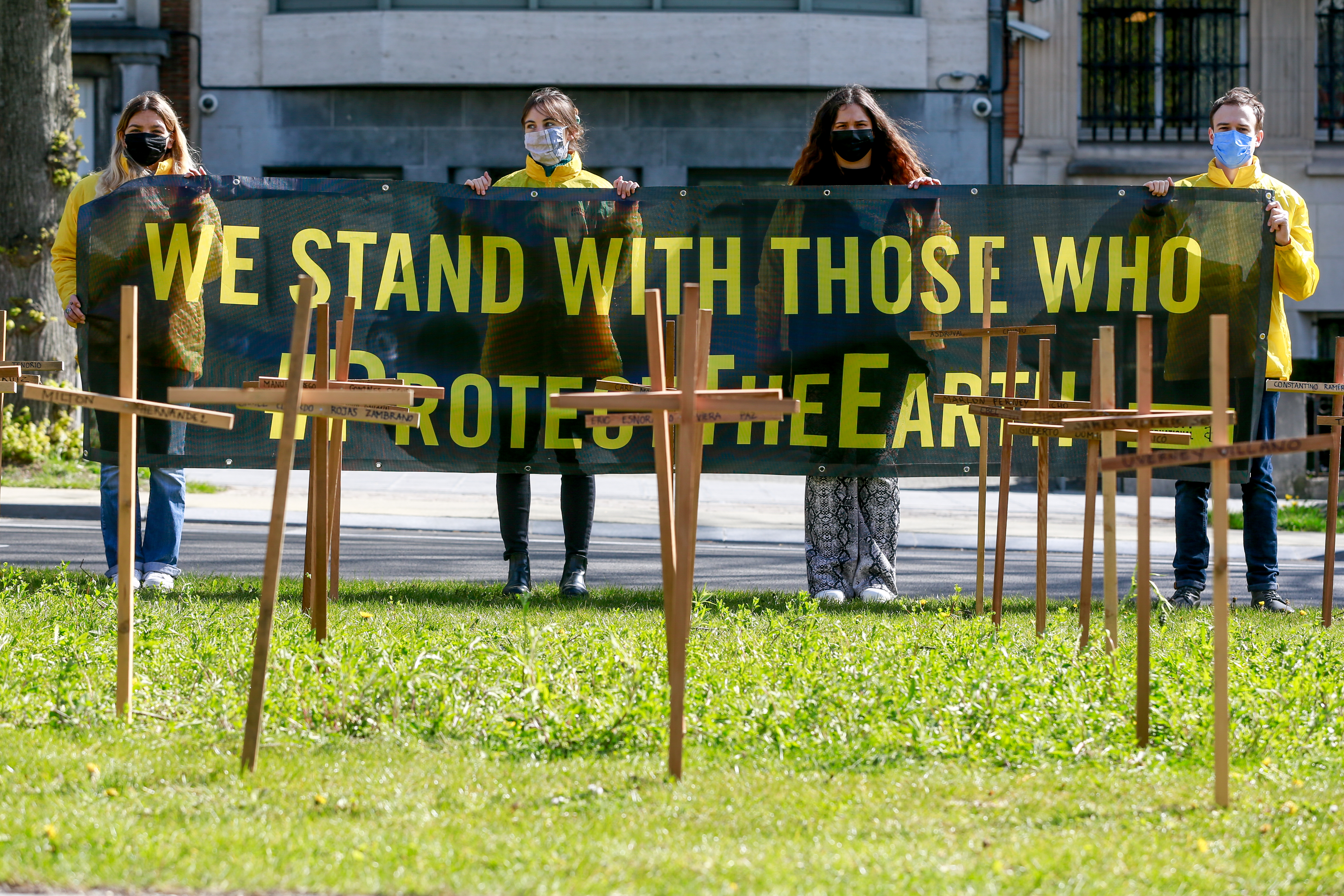 Activists gather around crosses in front of the Colombian Embassy in Brussels, Belgium bearing the names of the 64 environmental defenders murdered in Colombia in 2019 - 2020 was deadlier [File: Stephanie Lecocq/EPA-EFE]