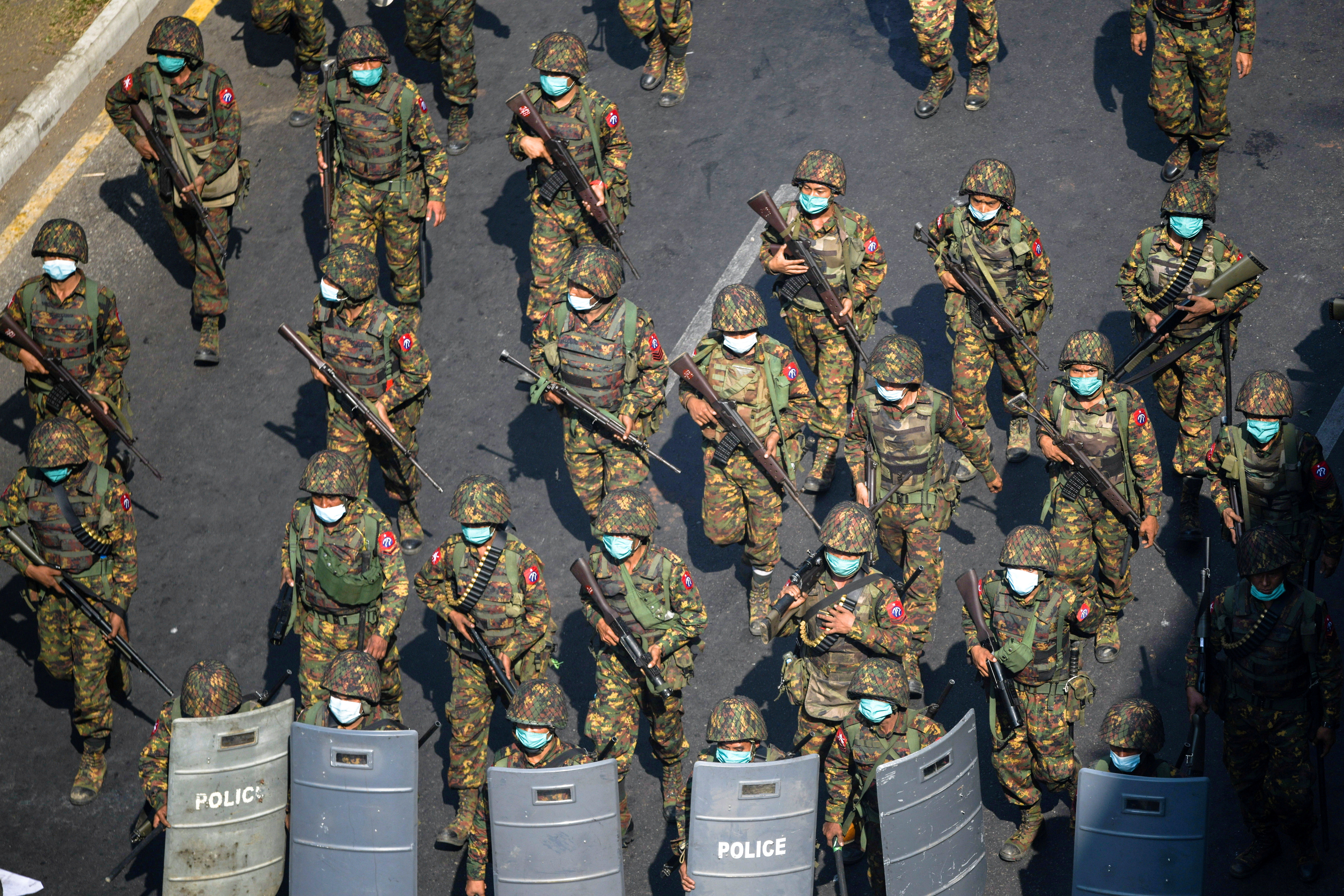 Myanmar soldiers walk along a street during a protest against the military coup in Yangon, Myanmar, February 28, 2021.