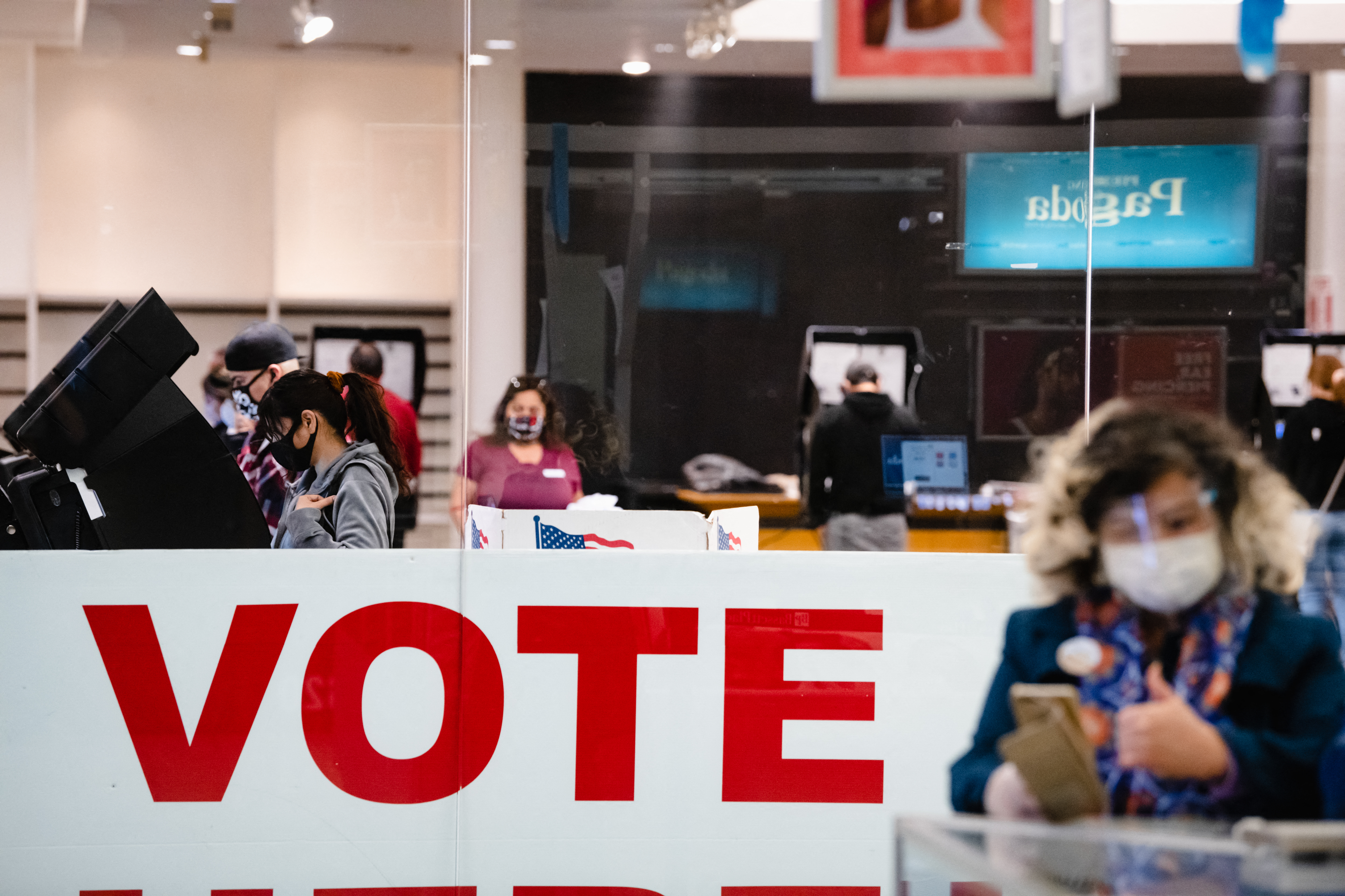 A woman casts her ballot in the 2020 general election inside the Basset Place mall in El Paso, Texas on November 3, 2020 [Justin Hamel/AFP]
