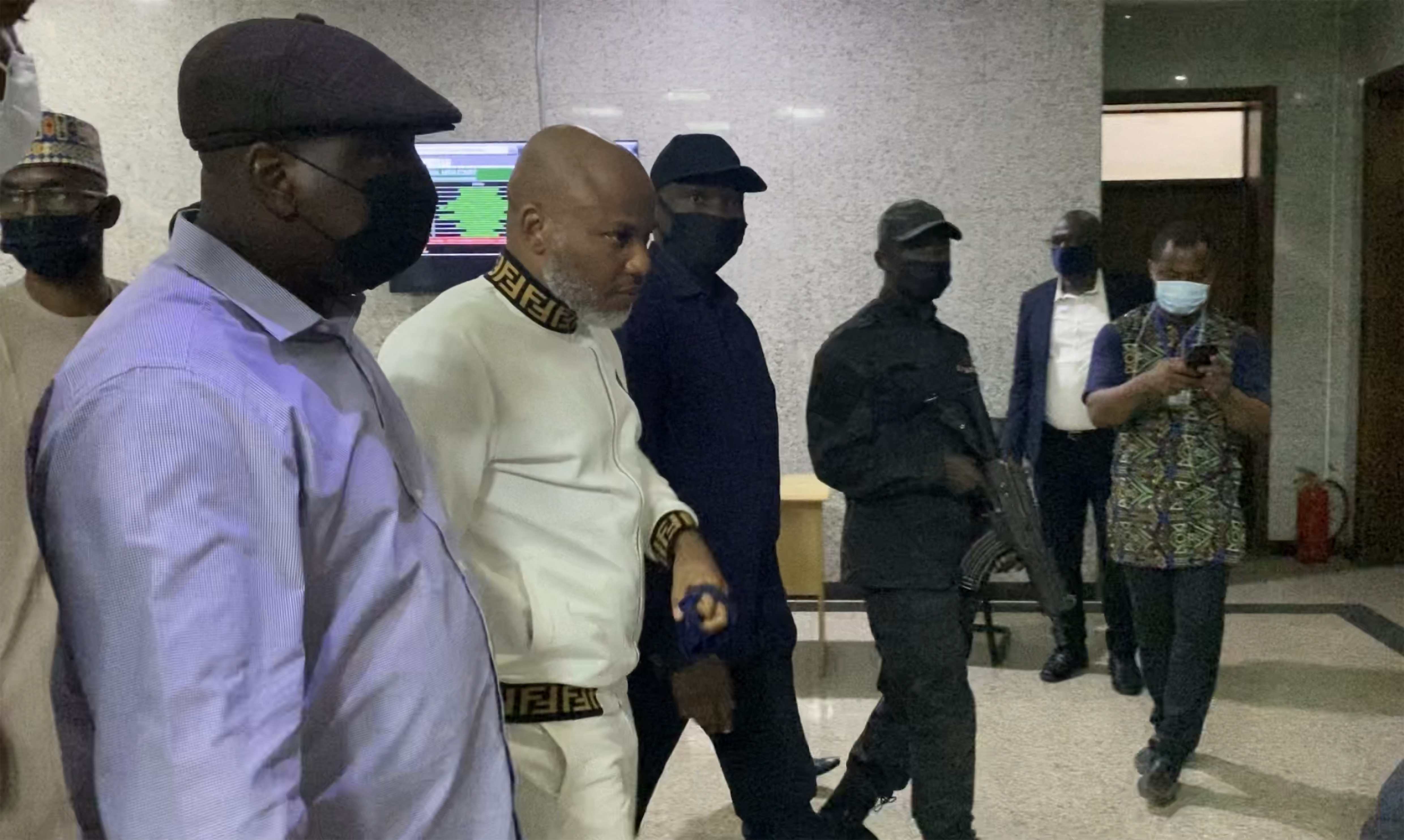 Nigerian state police escort Nnamdi Kanu, second from left, outside the Federal High Court in Lagos, Nigeria in October 2021 [File: Kola Sulaimon/AFP]
