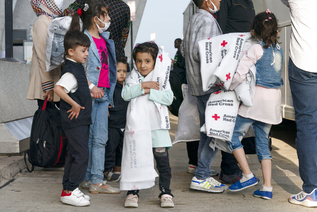 Families evacuated from Kabul, Afghanistan, arrive at Washington Dulles International Airport near Washington, DC, August 26, 2021 [File: Jose Luis Magana/AP Photo]