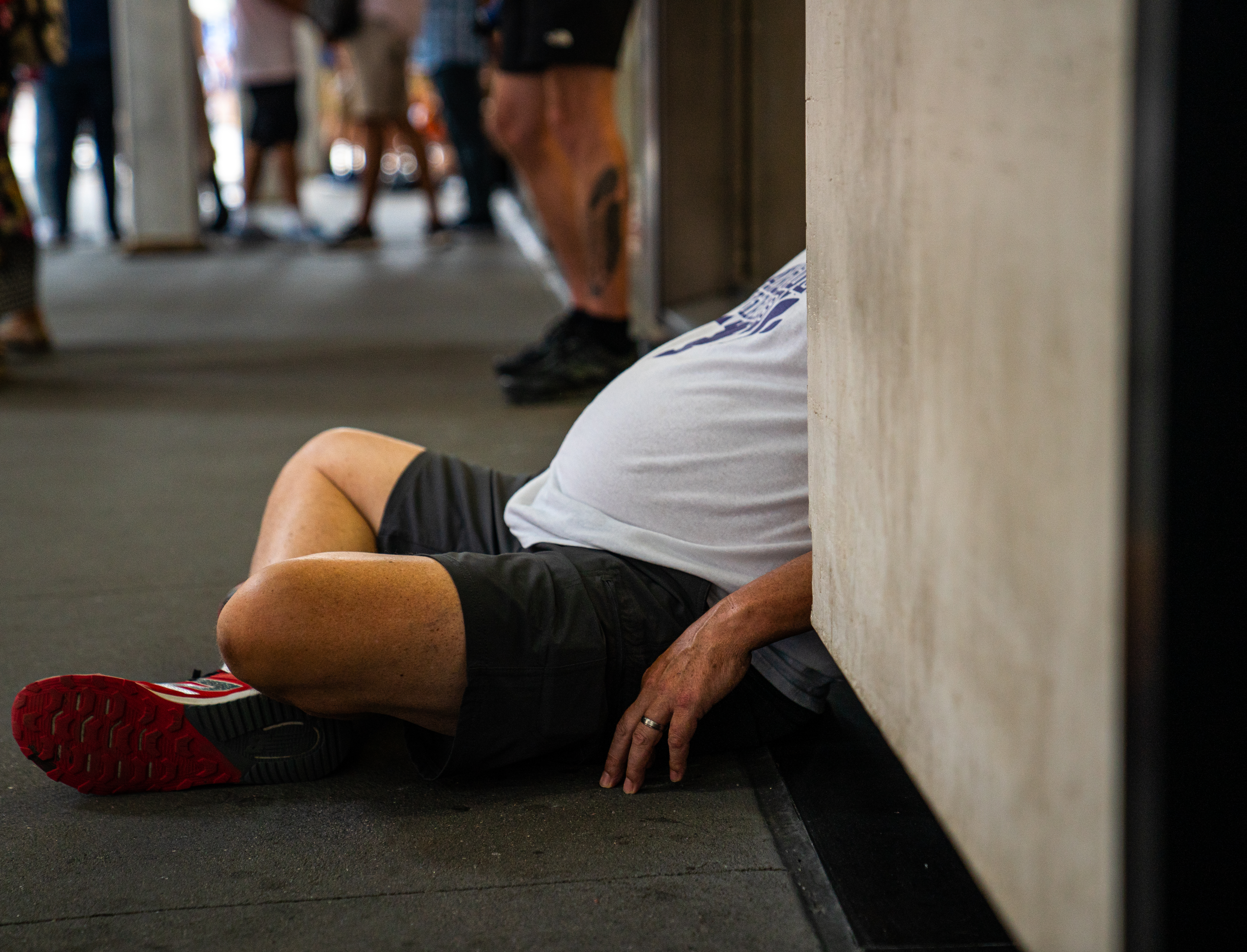 A man with excessive weight rests on a sidewalk July 5, 2021 in New York City. Obesity in the United States is a major health issue often causing early deaths and numerous diseases, specifically increased risk of certain types of cancer, heart attacks and strokes. [Robert Nickelsberg/Getty Image]