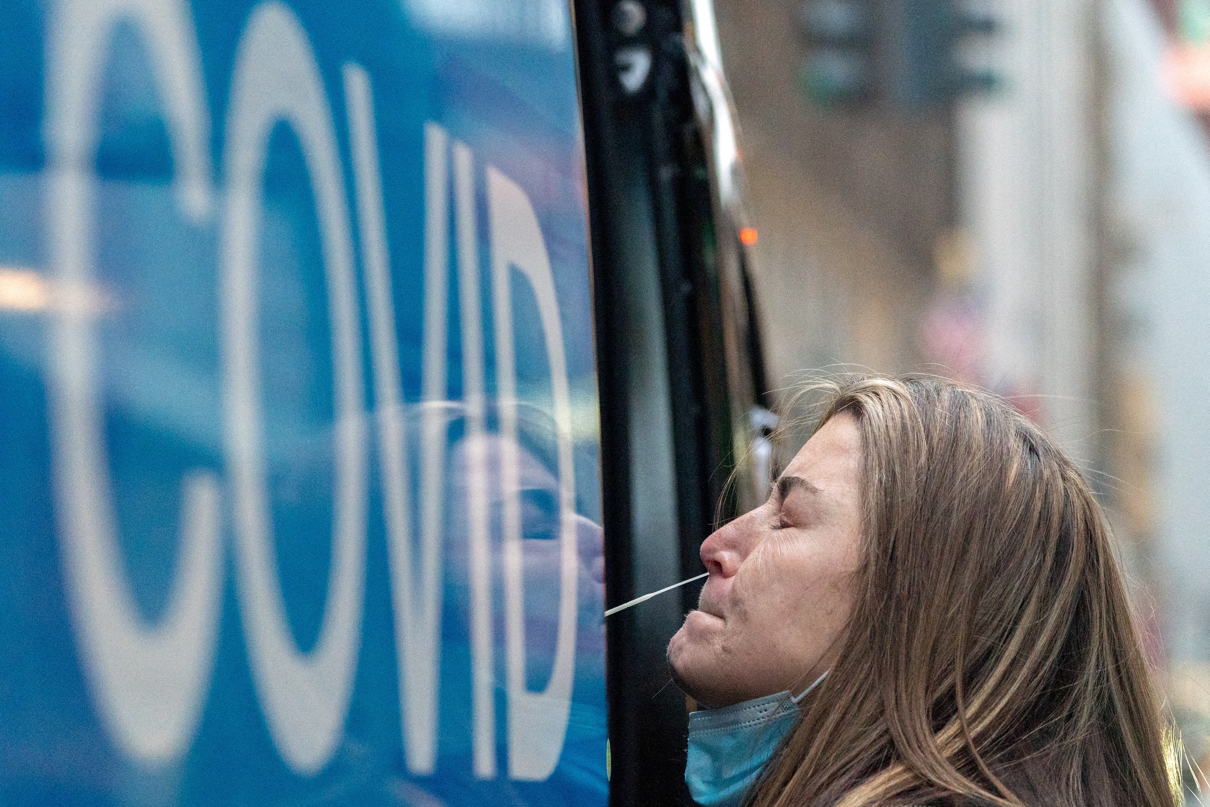 A woman takes a COVID-19 test at a pop-up testing site in New York City