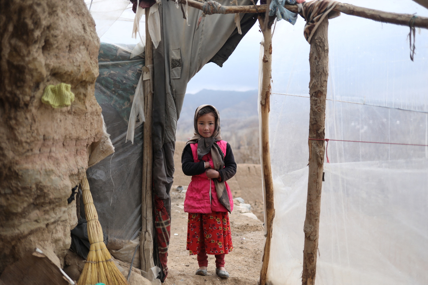 Mojgan, pose for a photograph in the doorway of a house in Bamiyan, Afghanistan