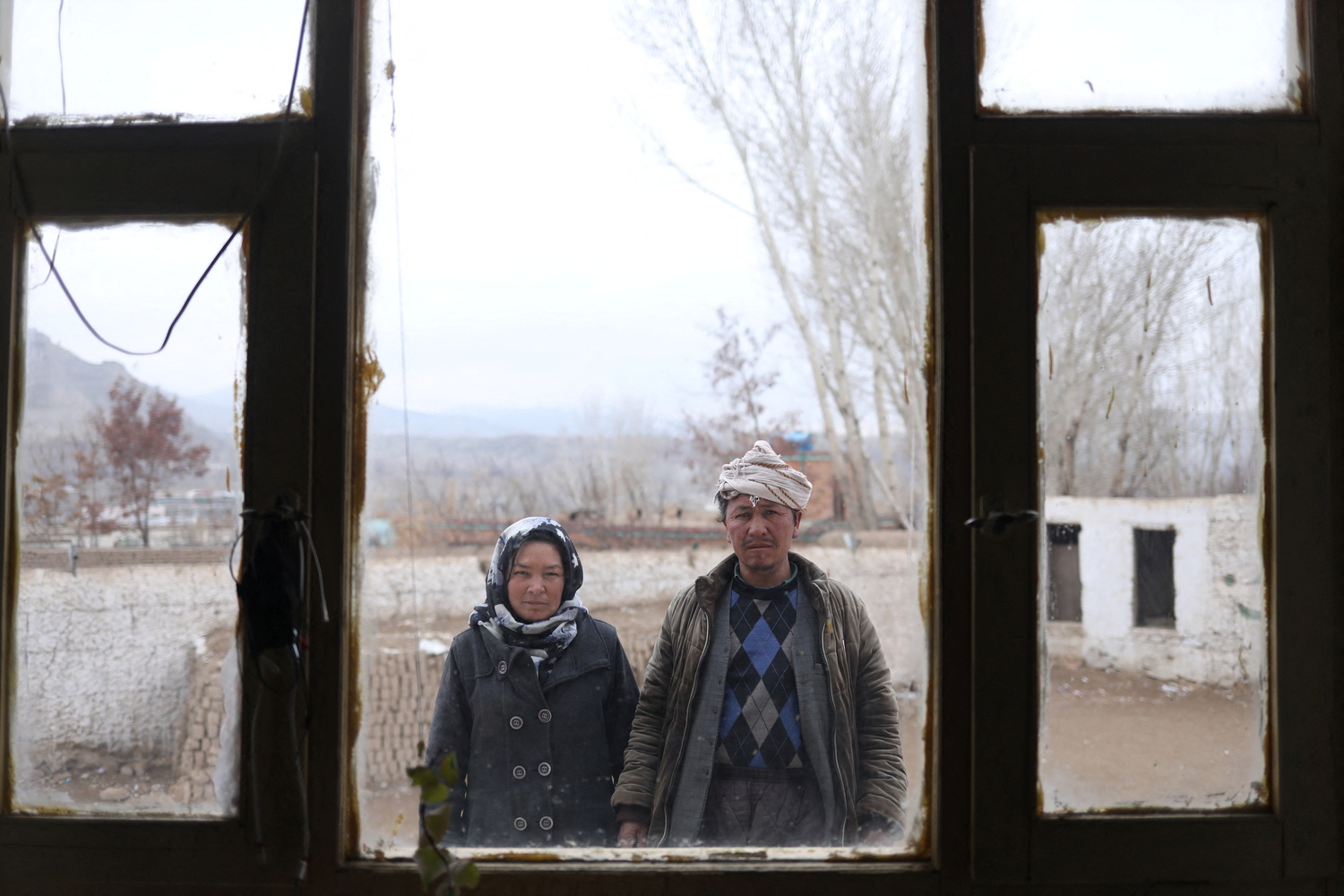 Sharifa, and her husband, Mohammad Amin, pose for a photograph