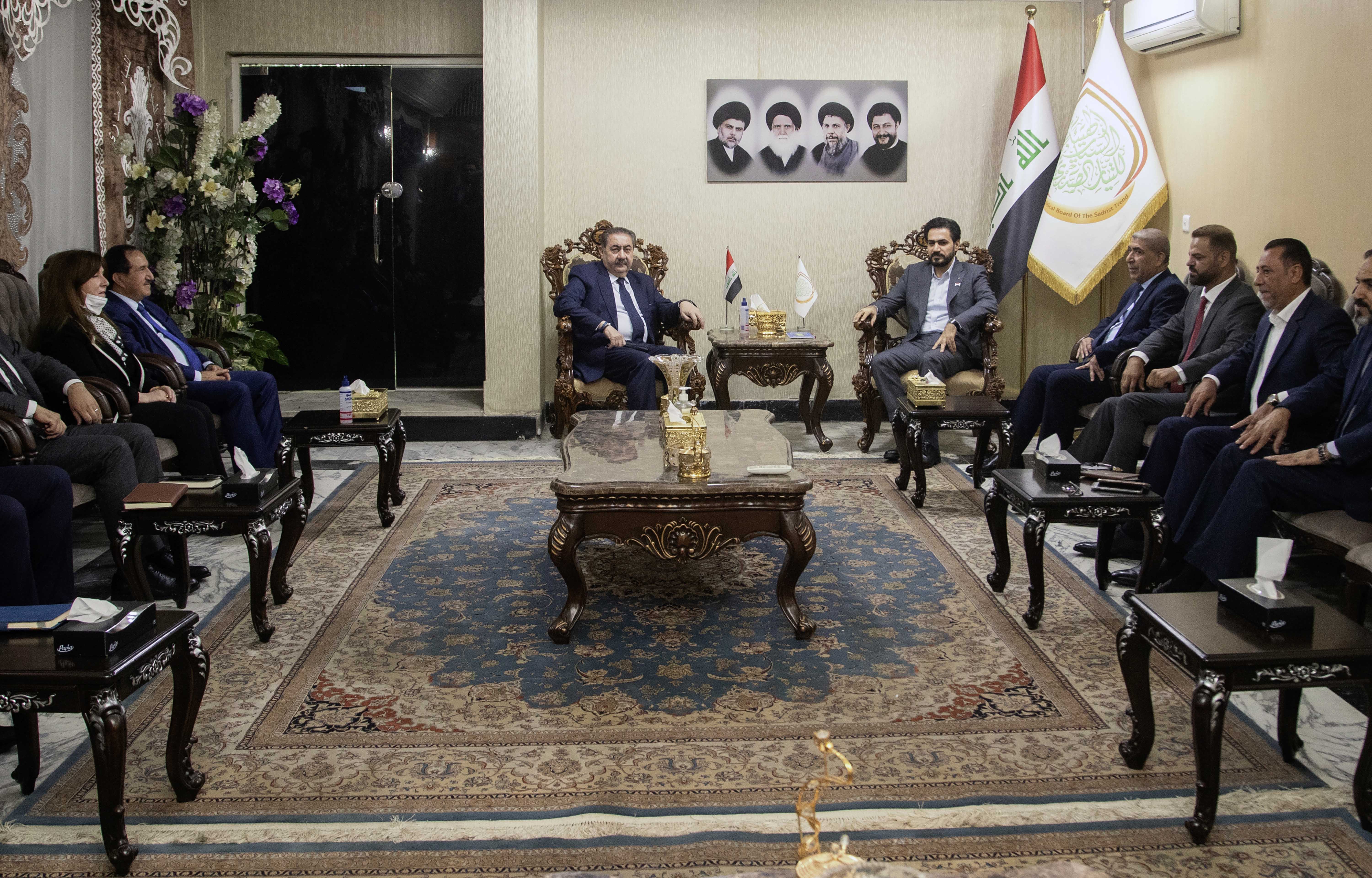 Hassan Al-Adari, head of the political body of the Sadrist bloc and Sadrists delegation meets with Hoshyar Zebari, head of the Kurdish delegation to negotiations on forming the new government after the parliamentary elections in Baghdad on November 5, 2021 [File: AP/Hadi Mizban]