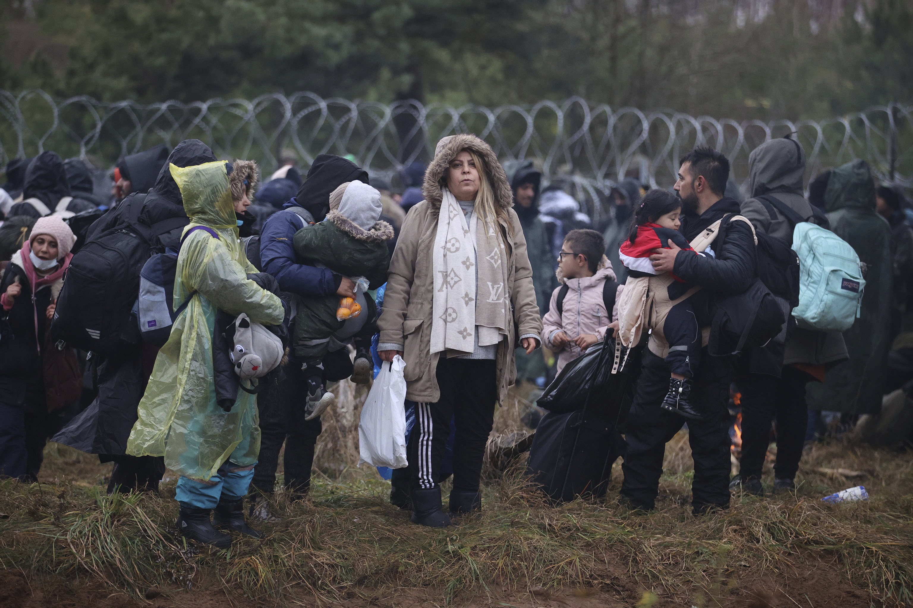 Migrants from the Middle East and elsewhere gather at the Belarus-Poland border