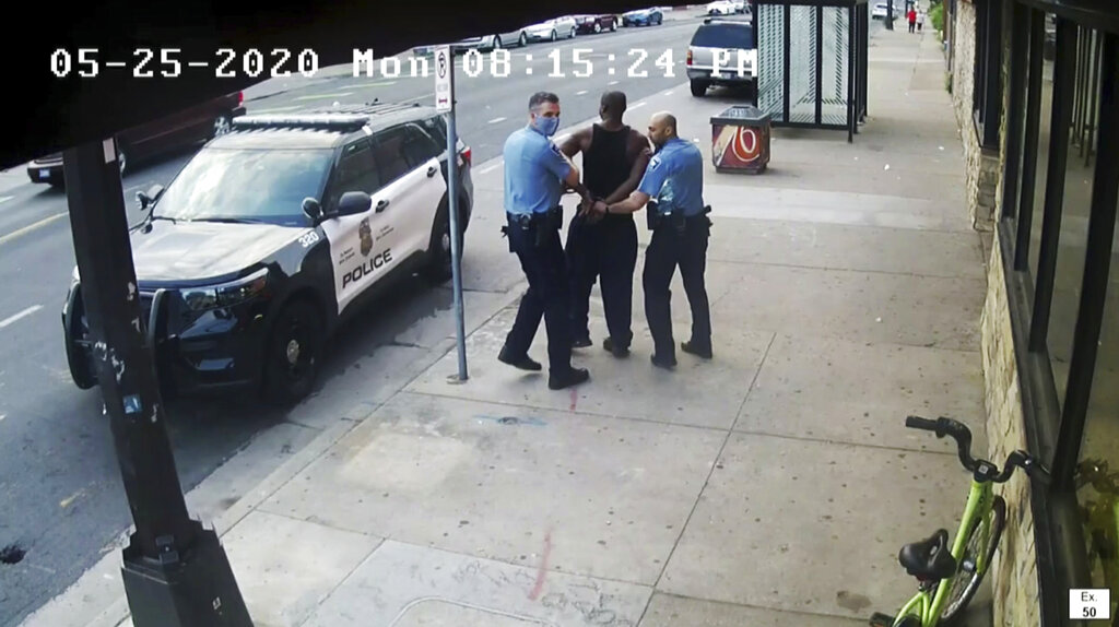 This image from video shows Minneapolis police Officers Thomas Lane, left and J. Alexander Kueng, right, escorting George Floyd, center, to a police vehicle outside Cup Foods in Minneapolis, on May 25, 2020.