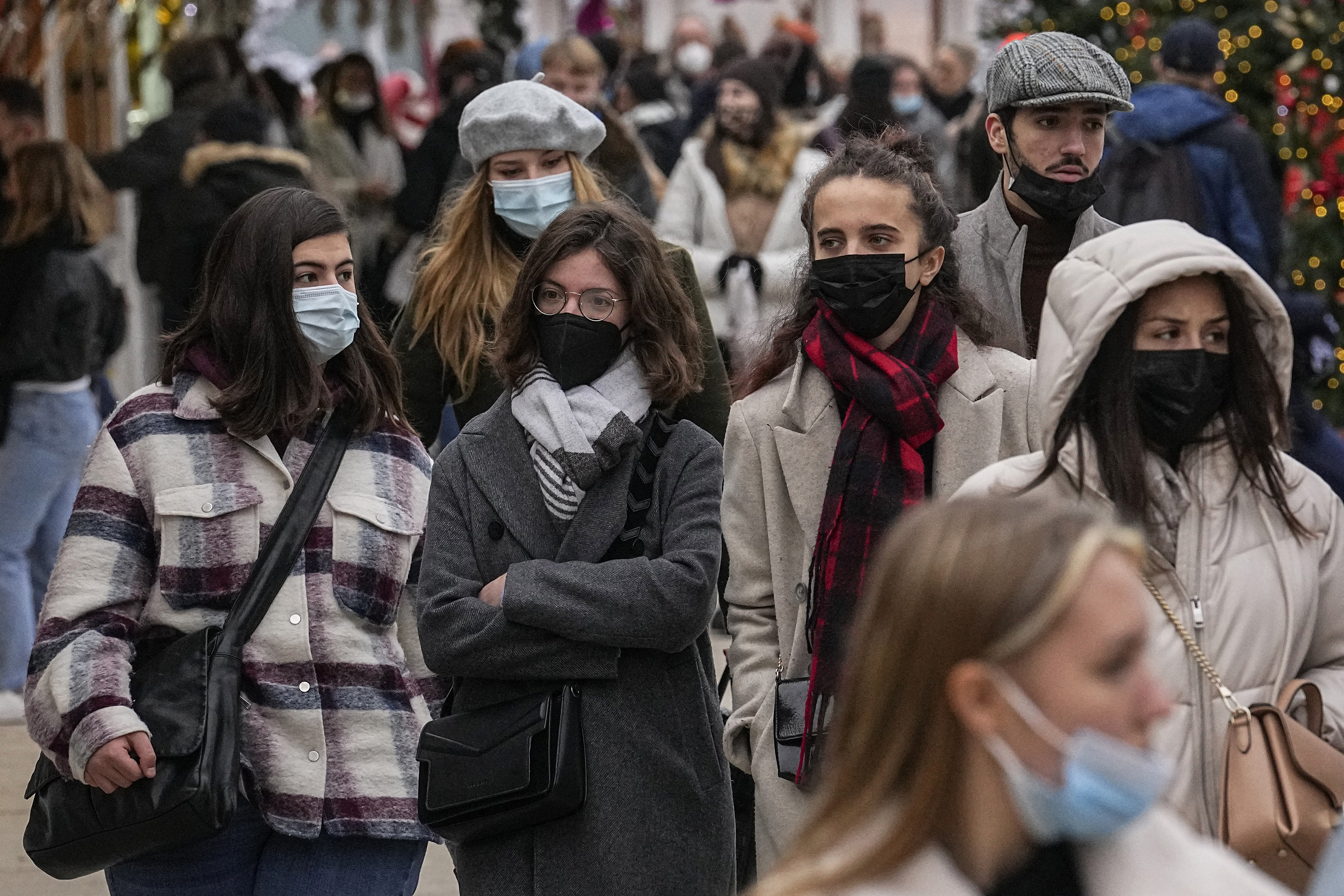 People wearing face masks to protect against COVID-19 walk in Paris