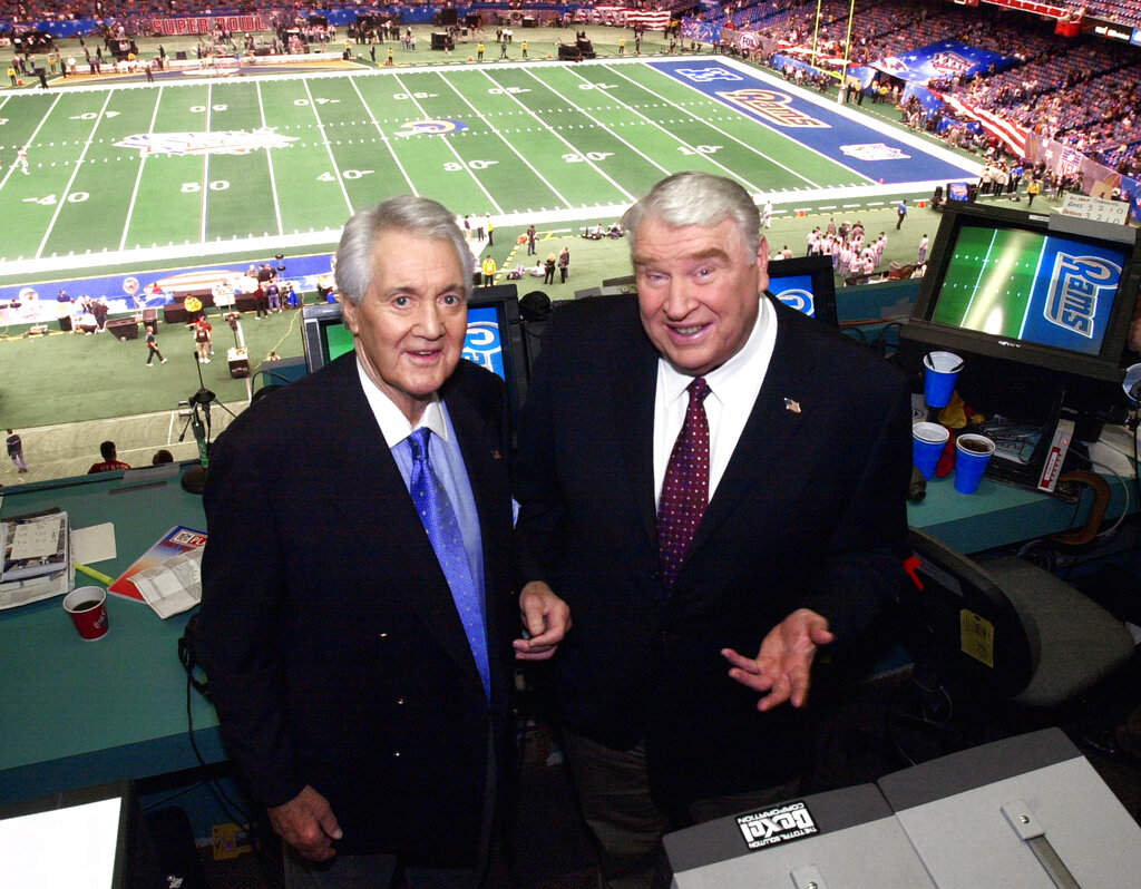 Fox broadcasters Pat Summerall and John Madden stand in the broadcast booth at the Superdome before Super Bowl 36 in 2002, in New Orleans.