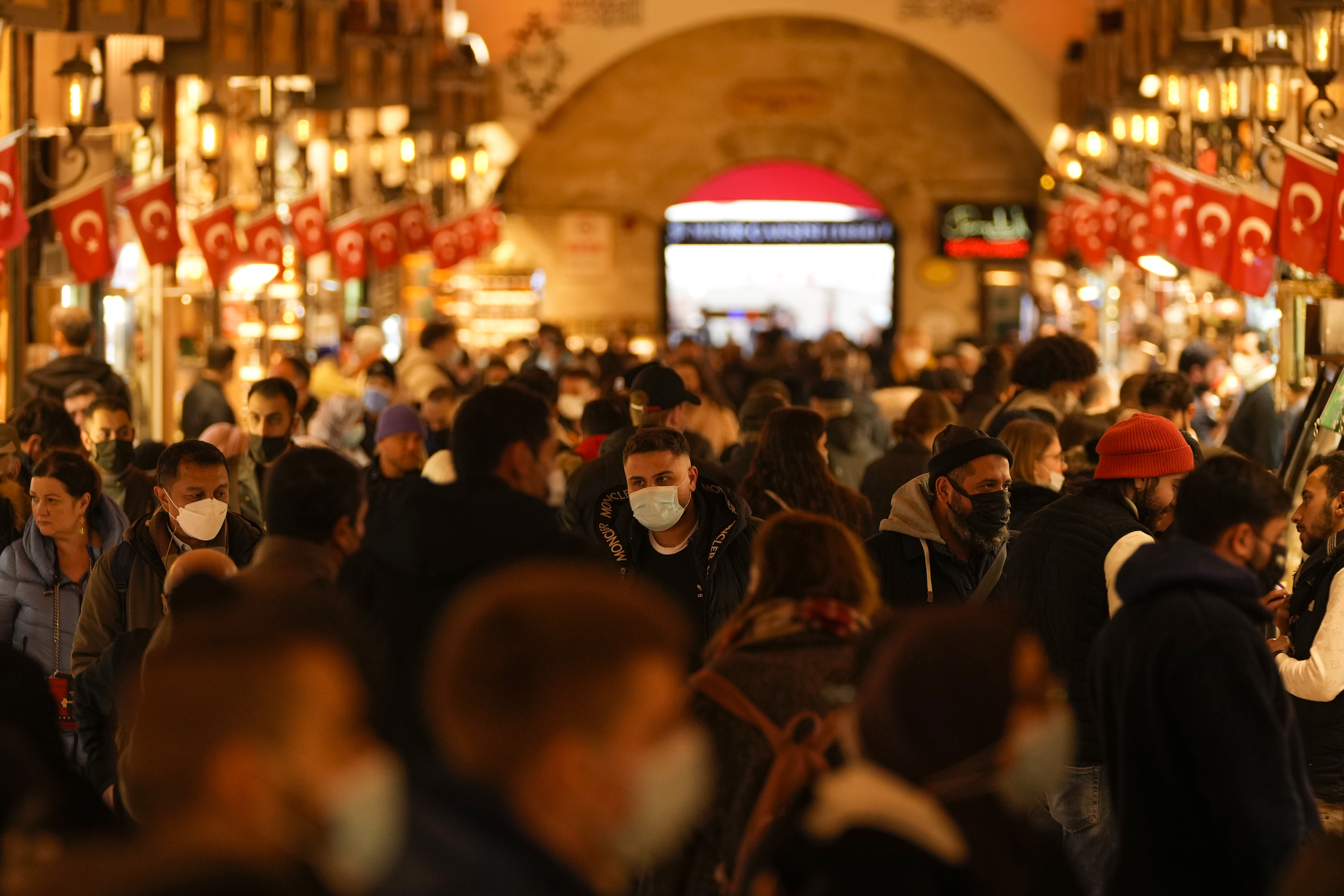 A crowd of people are seen walking inside the Egyptian Bazaar , Istanbul