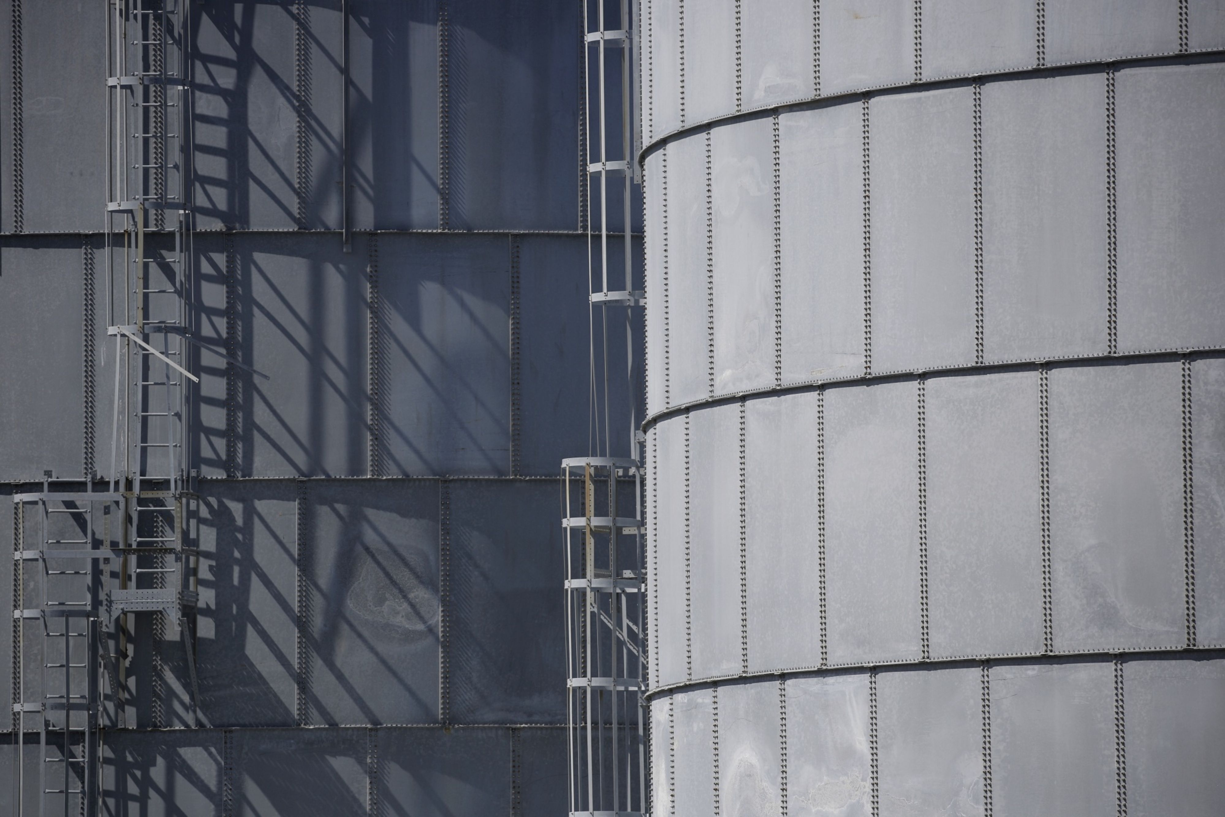 Storage tanks located near a dock for Hornbeck Offshore Services, Inc. oil industry support vessels in Port Fourchon, Louisiana, United States