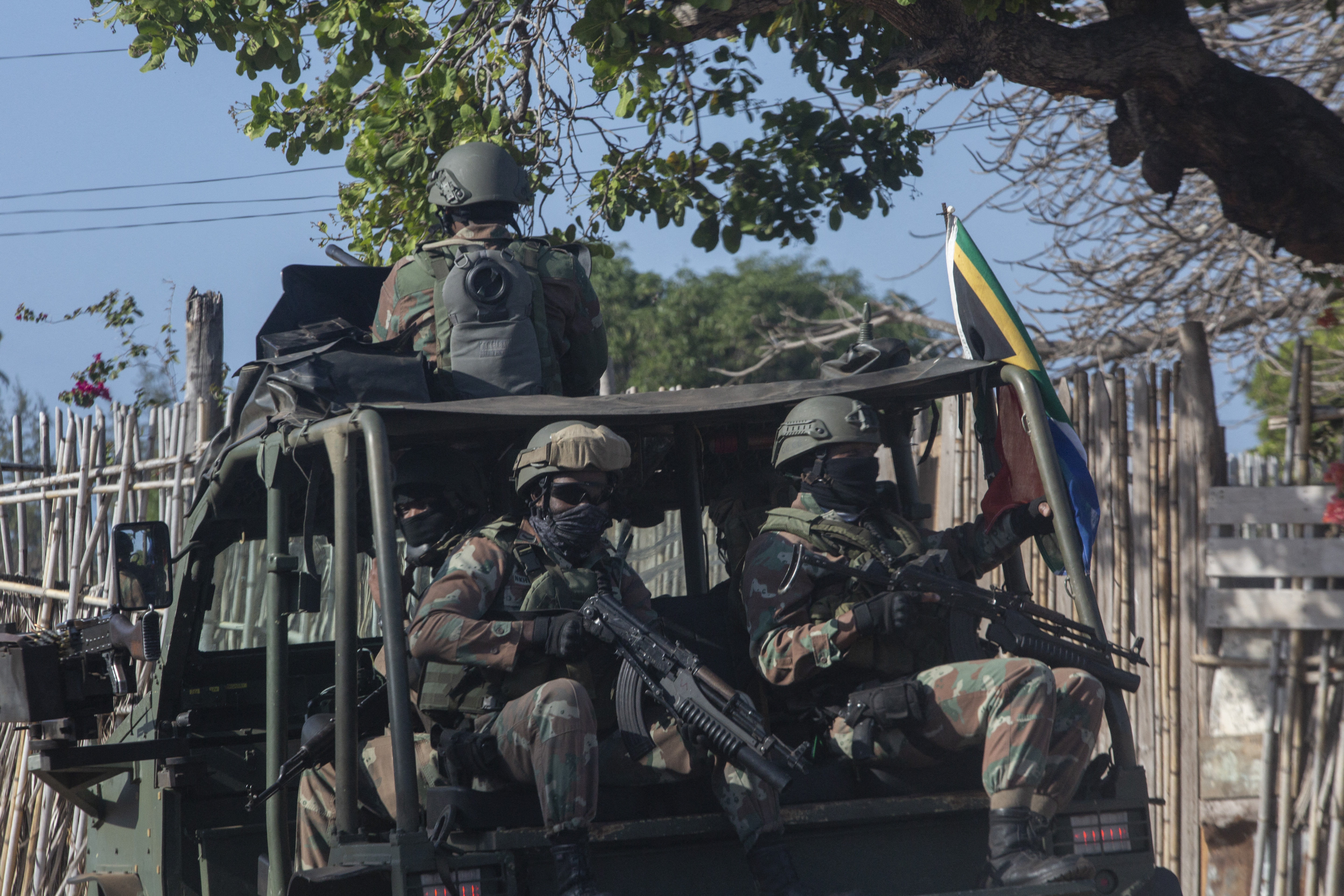 A military convoy of South Africa National Defence Forces (SANDF) rides along a dirt road in the Maringanha district in Pemba, Mozambique