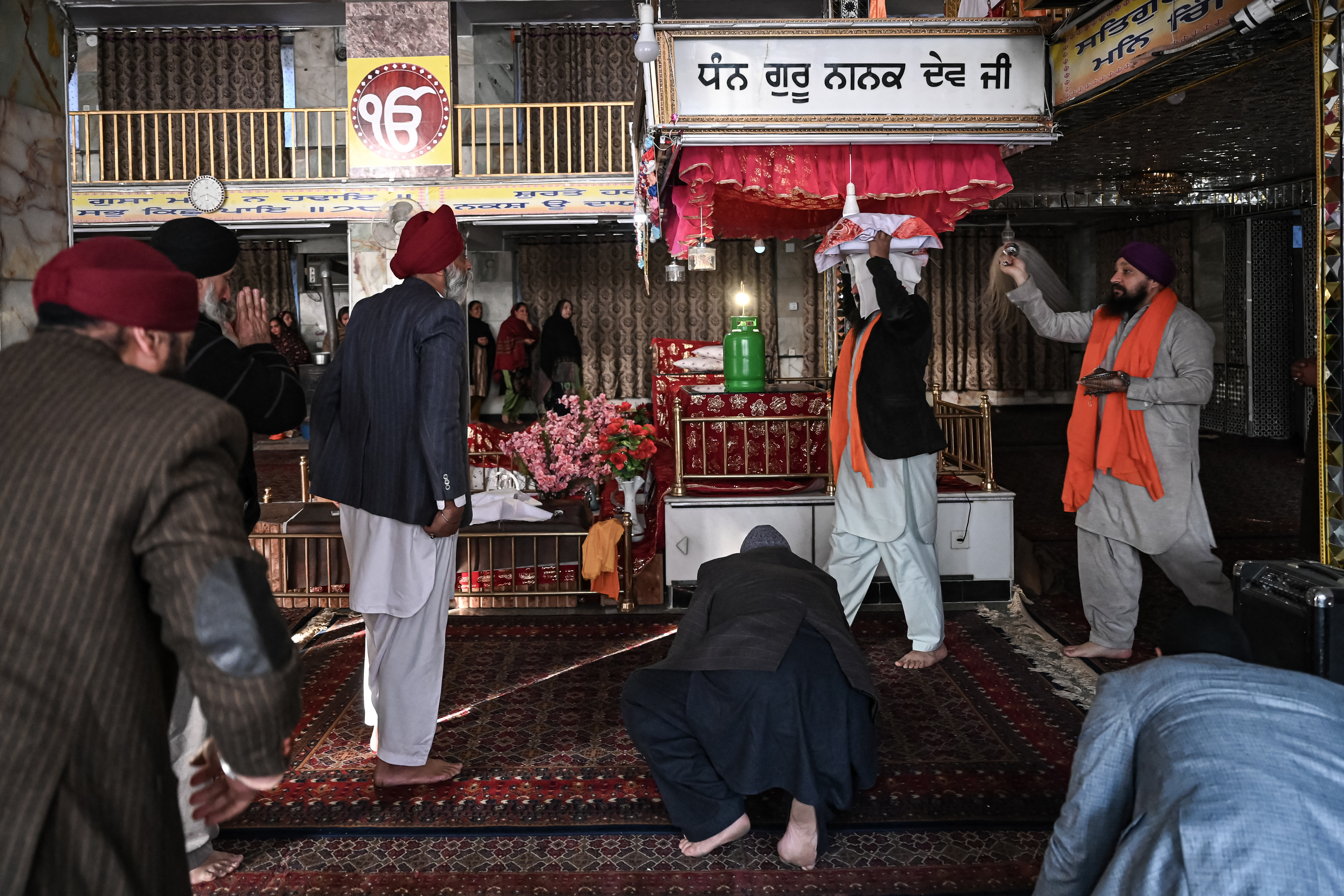 Afghan Sikh priest carrying the Guru Granth Sahib, the Sikh holy book, at the Karte Parwan Gurdwara temple in Kabul