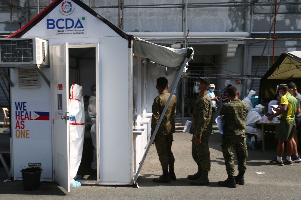 Filipino military personnel queue up for coronavirus swab tests outside a gymnasium in Manila, the Philippines.s.