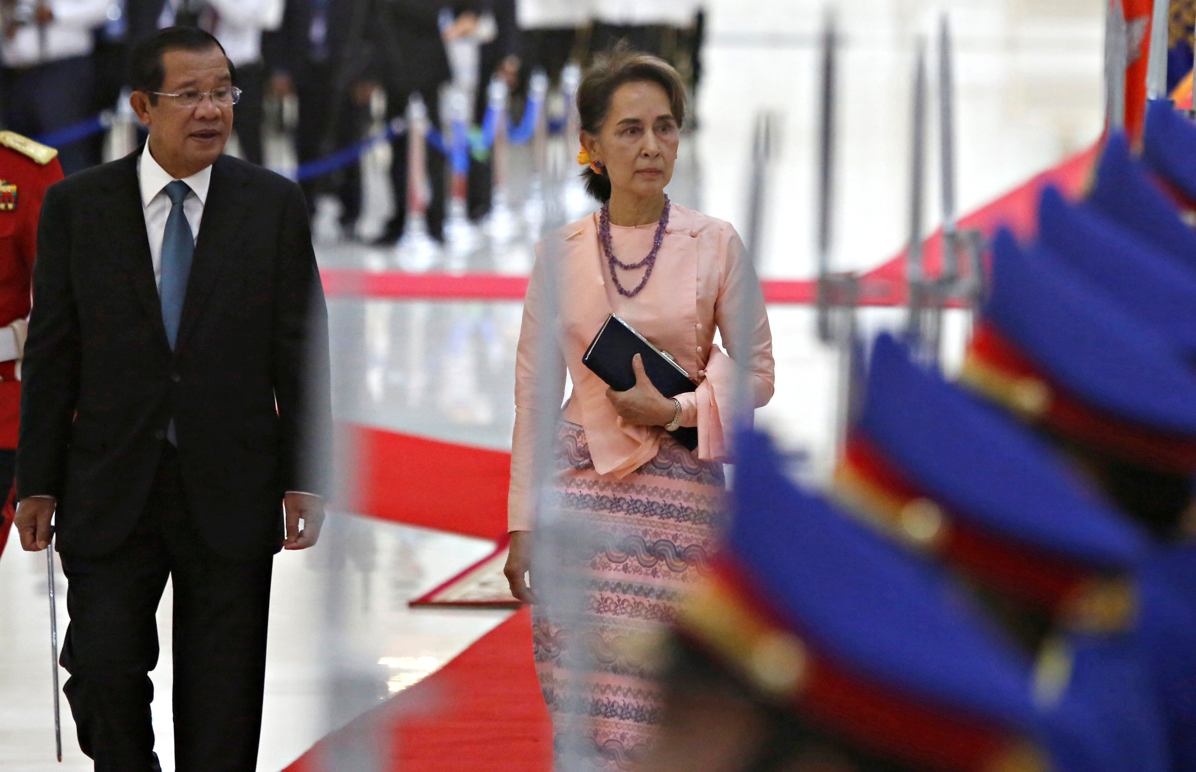 Myanmar's Aung San Suu Kyi and Cambodia's Prime Minister Hun Sen inspect an honour guard at the Peace Palace in Phnom Penh, Cambodia, April 30, 2019.