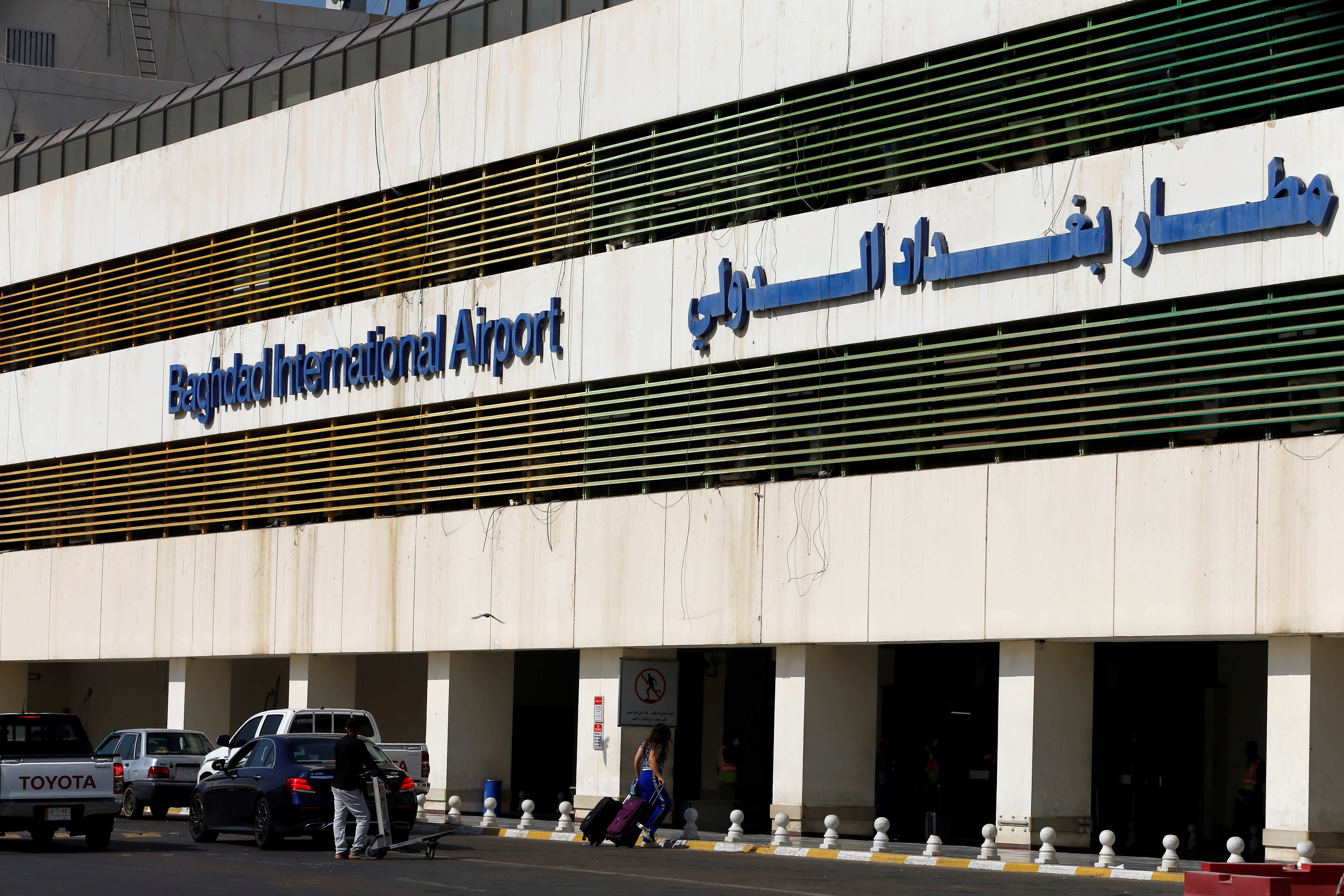 Passengers arrive at Baghdad International Airport, where flights halted due to the coronavirus disease (COVID-19) outbreak, after its reopening, in Baghdad, Iraq, July 23, 2020. [Thaier Al-Sudani/Reuters]
