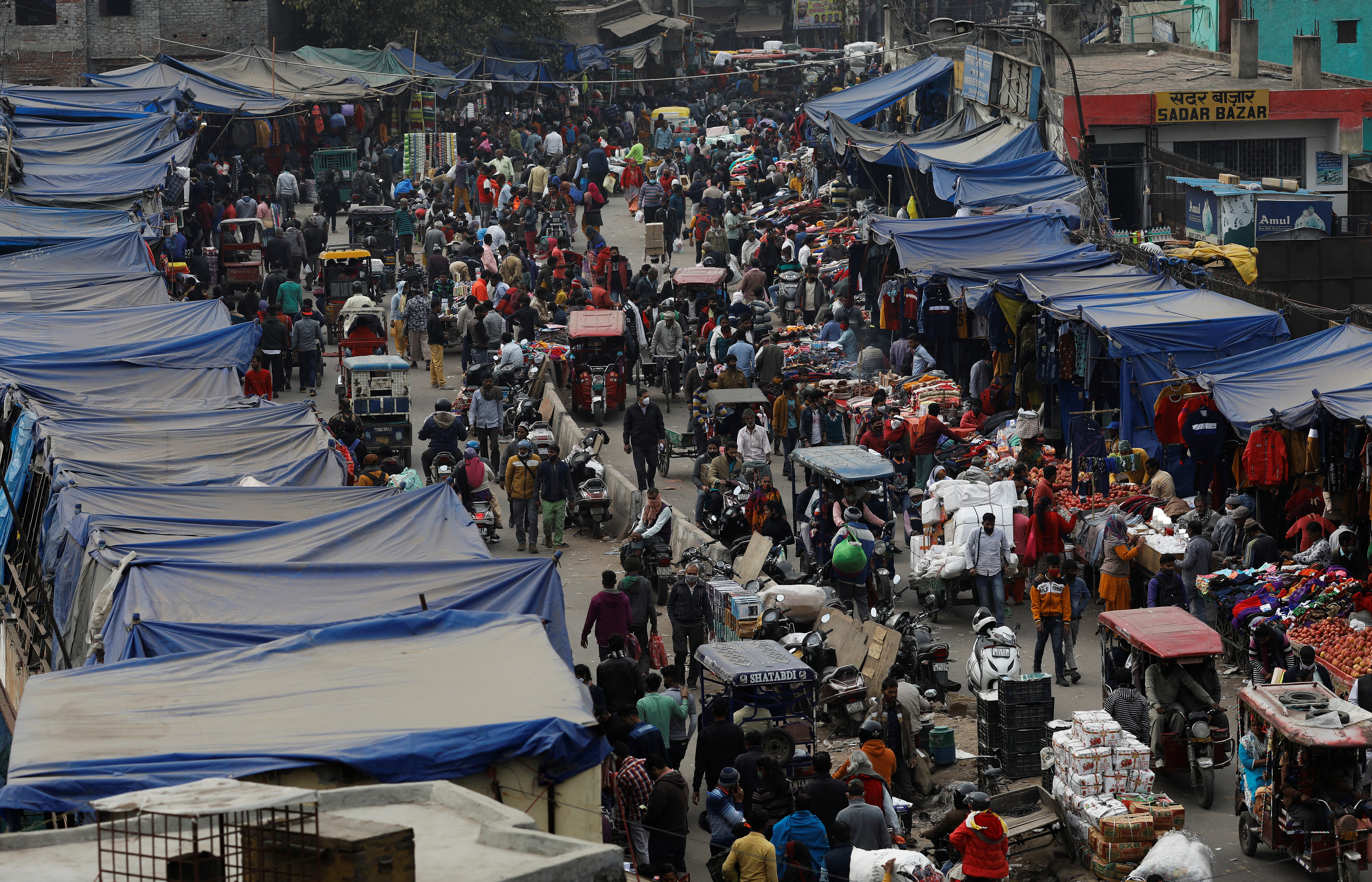People shop at a crowded in the old quarters of Delhi, India