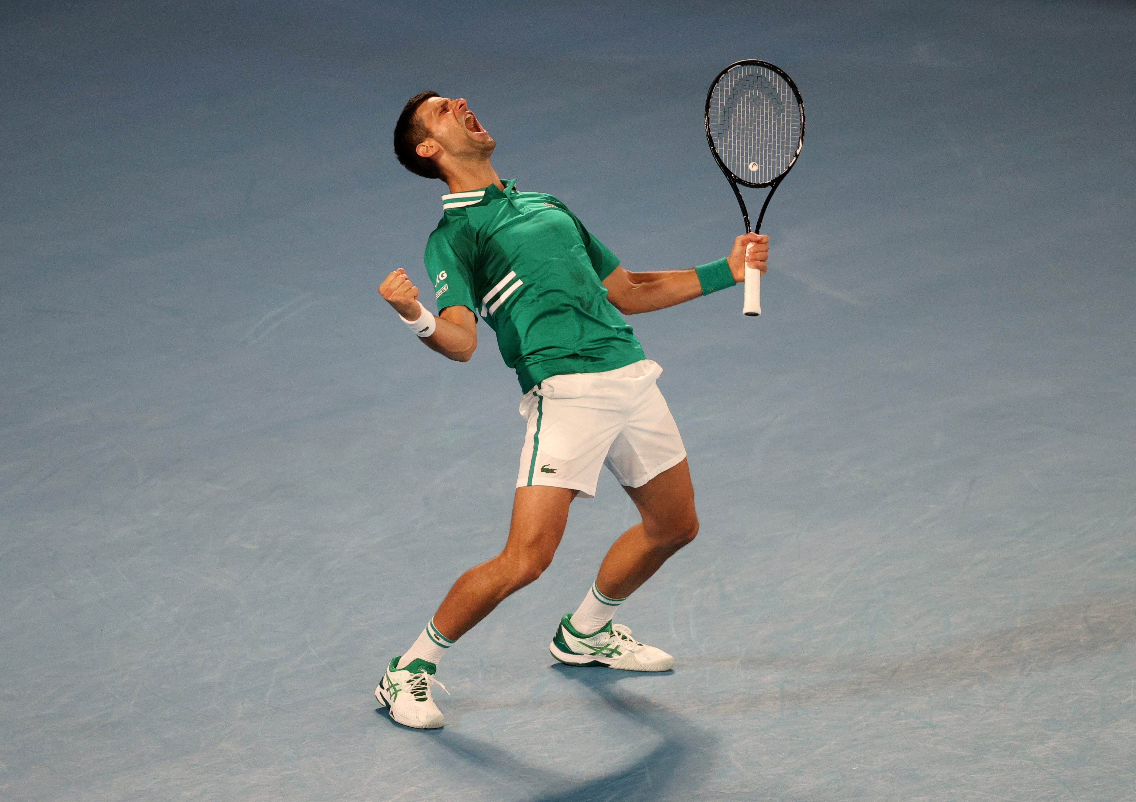 Novak Djokovic celebrates after winning match against Taylor Fritz