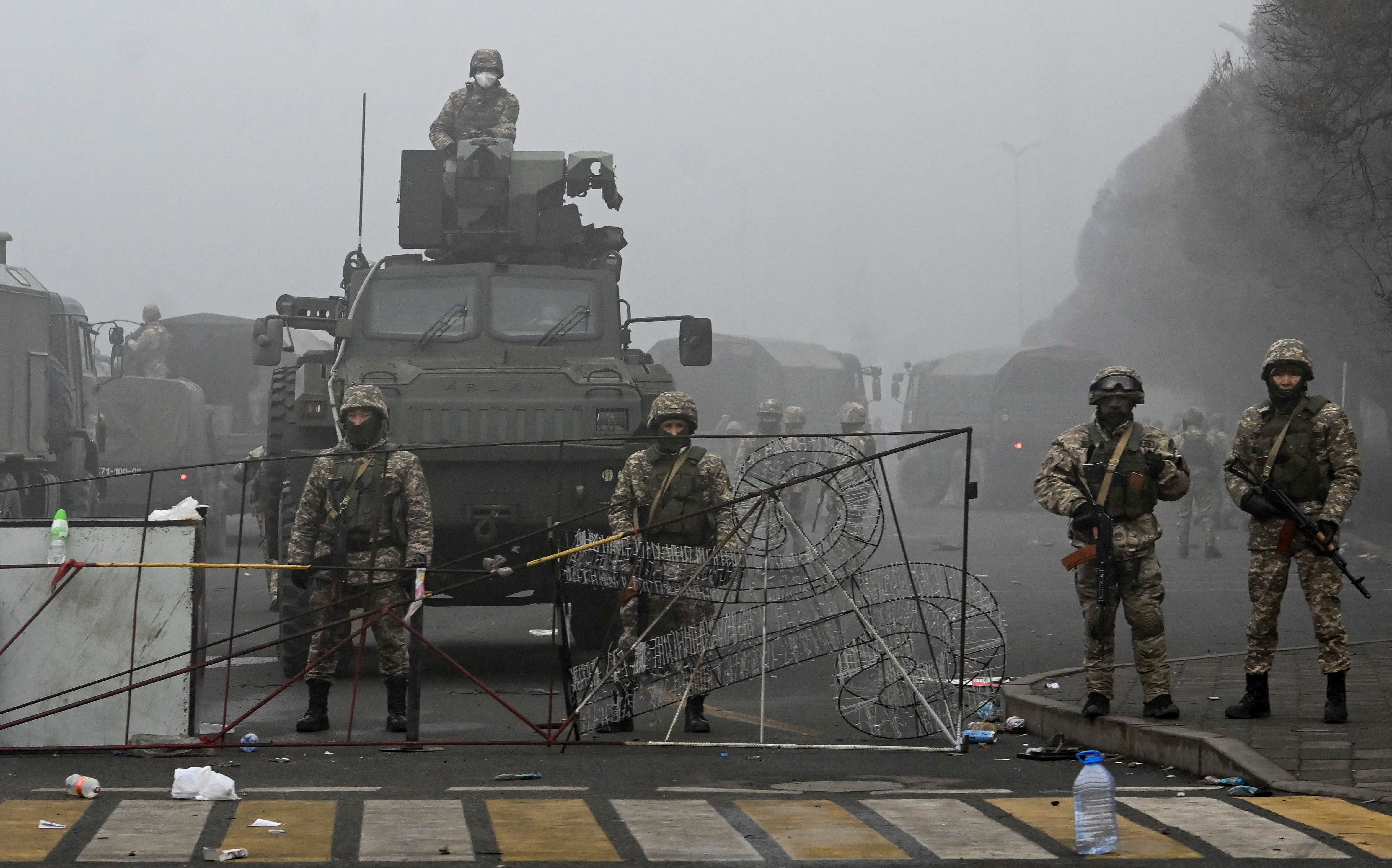 Troops at the main square where hundreds of people were protesting in Almaty