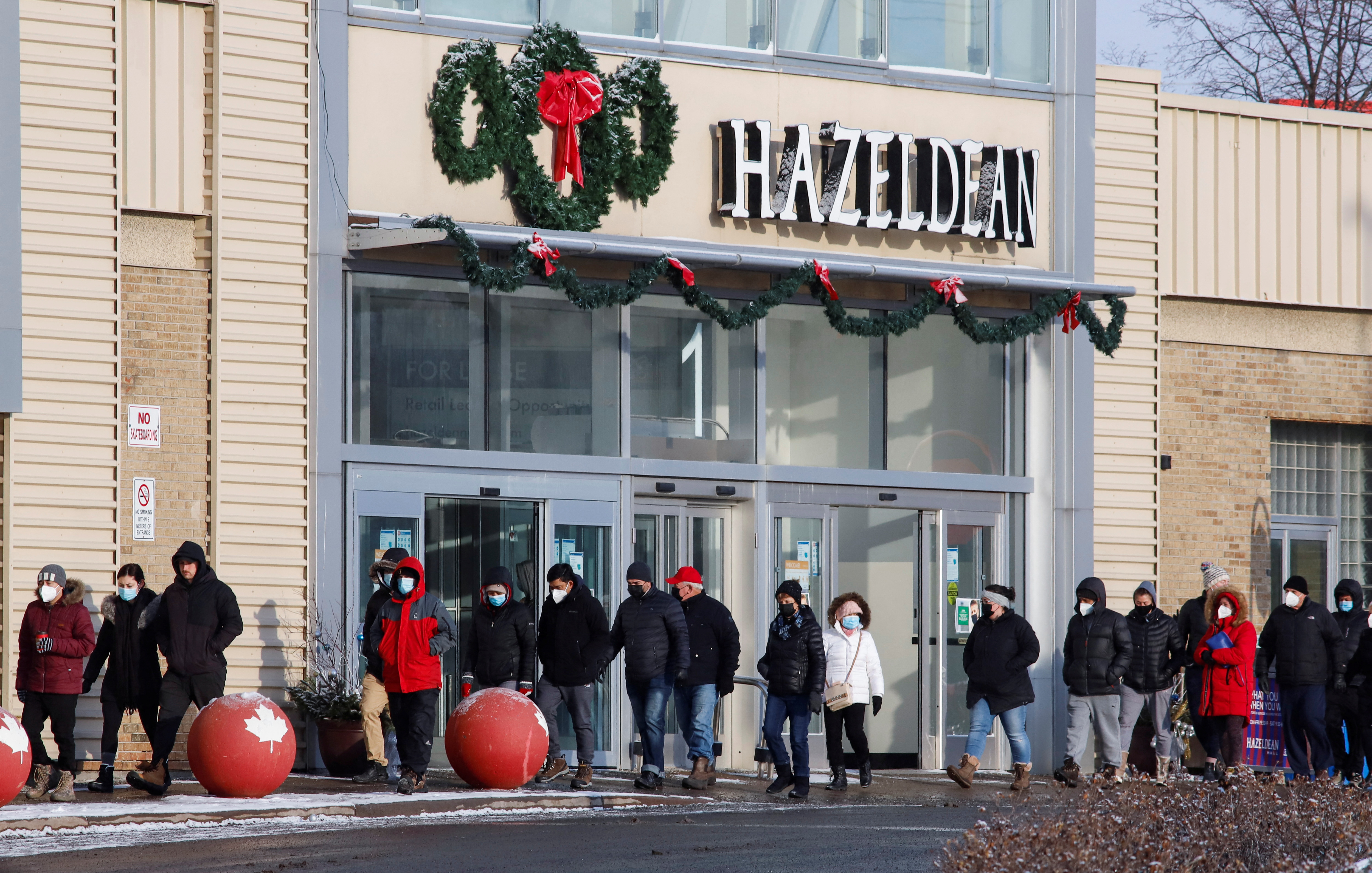 People queue to collect coronavirus disease (COVID-19) antigen test kits