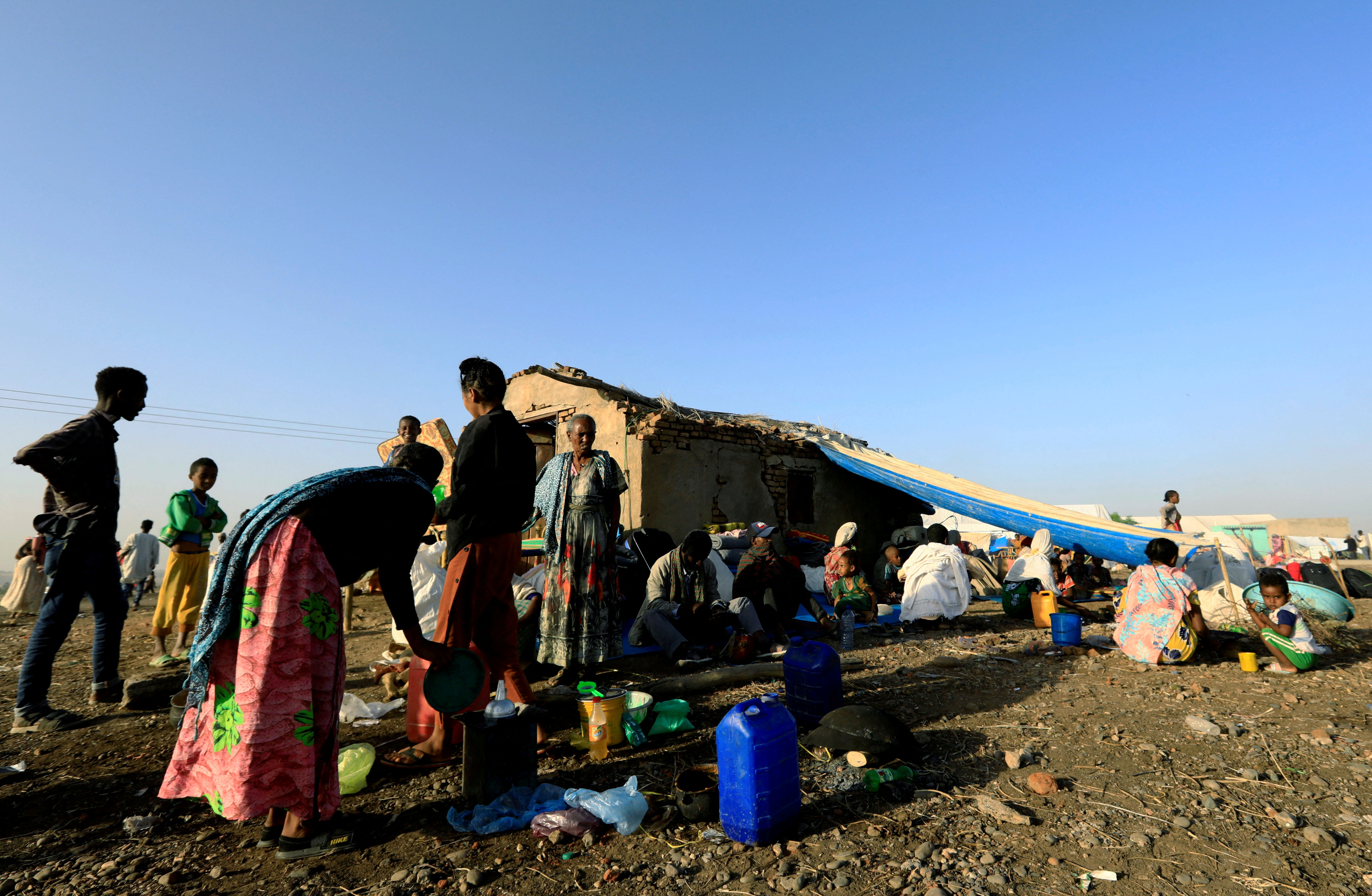 FILE PHOTO: Ethiopians who fled the ongoing fighting in Tigray region, gatherl in Hamdayet village near the Sudan-Ethiopia border, eastern Kassala state, Sudan November 22, 2020. REUTERS/Mohamed Nureldin Abdallah/File Photo