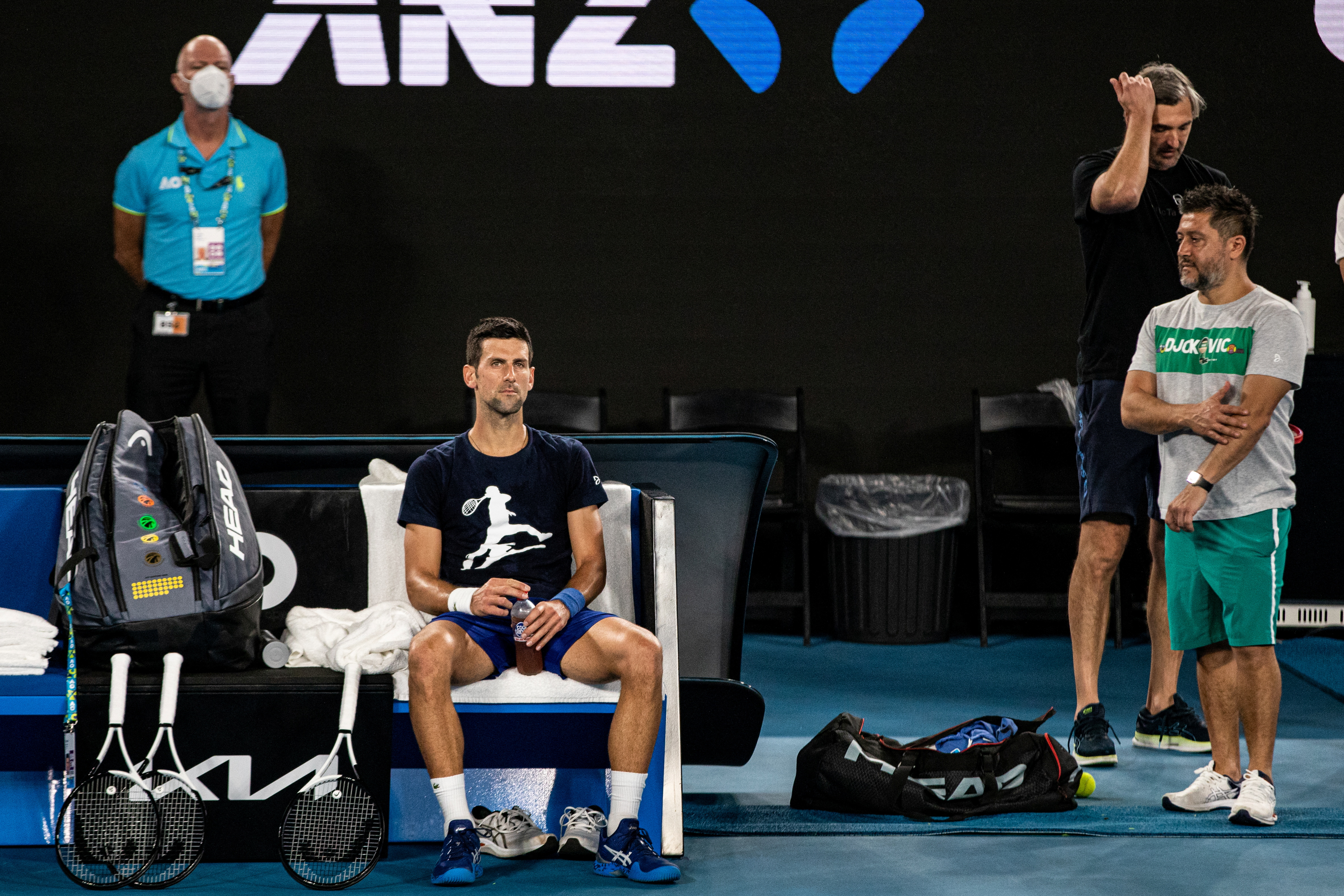 A Serbian tennis player Novak Djokovic sits on a bench