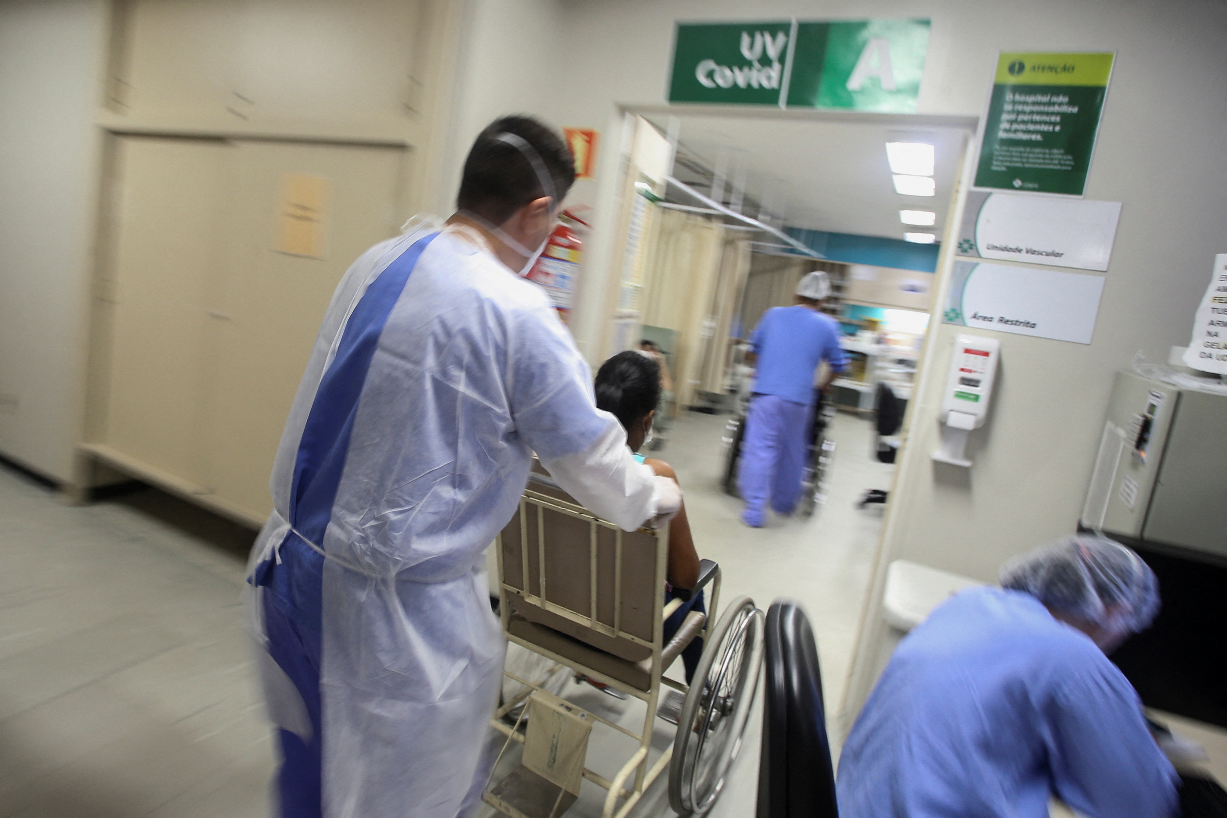 Health workers take care of a patient at a hospital in Porto Alegre, Brazil
