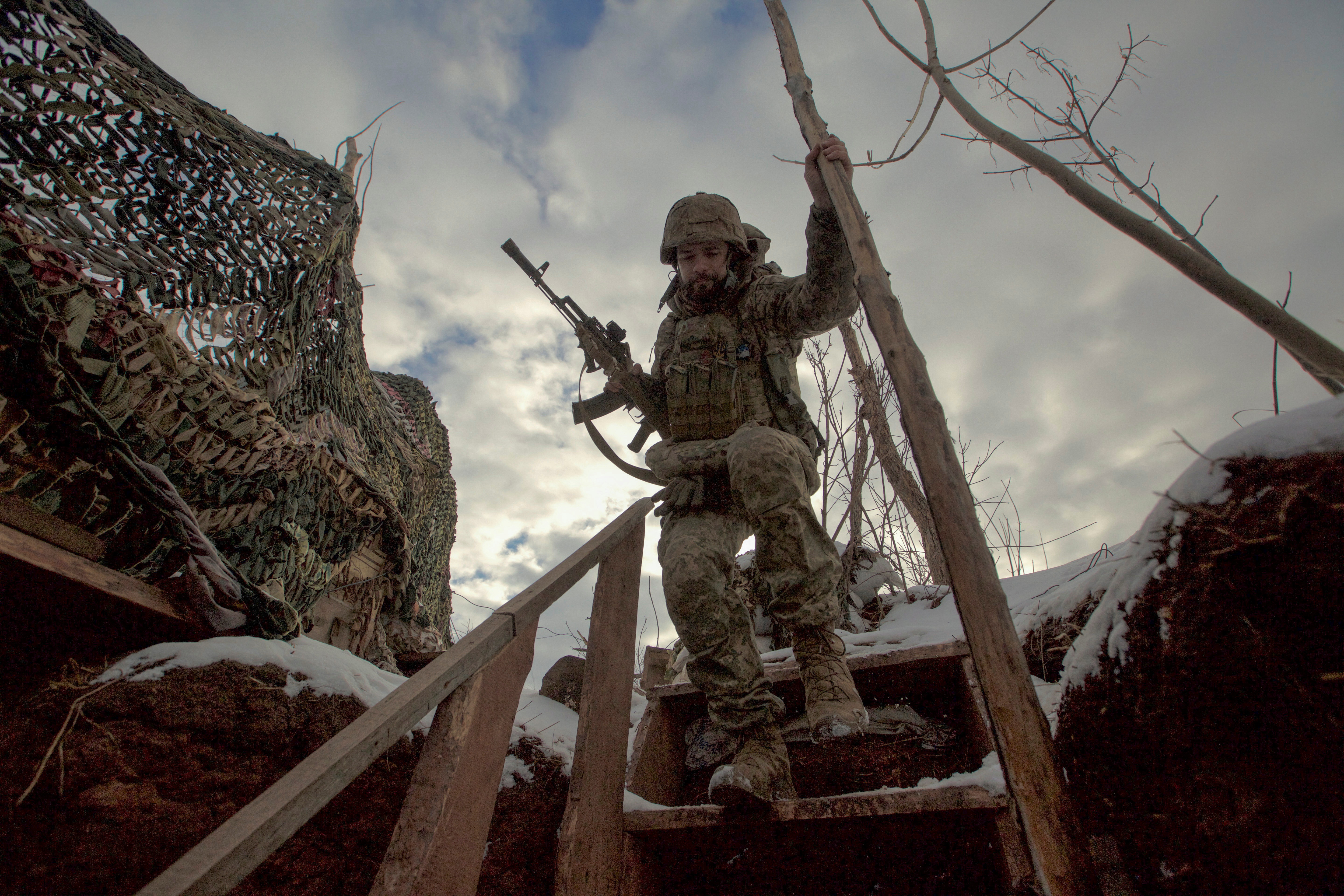 A service member of the Ukrainian armed forces walks at combat positions near the line of separation from Russian-backed rebels near Horlivka in the Donetsk region, Ukraine