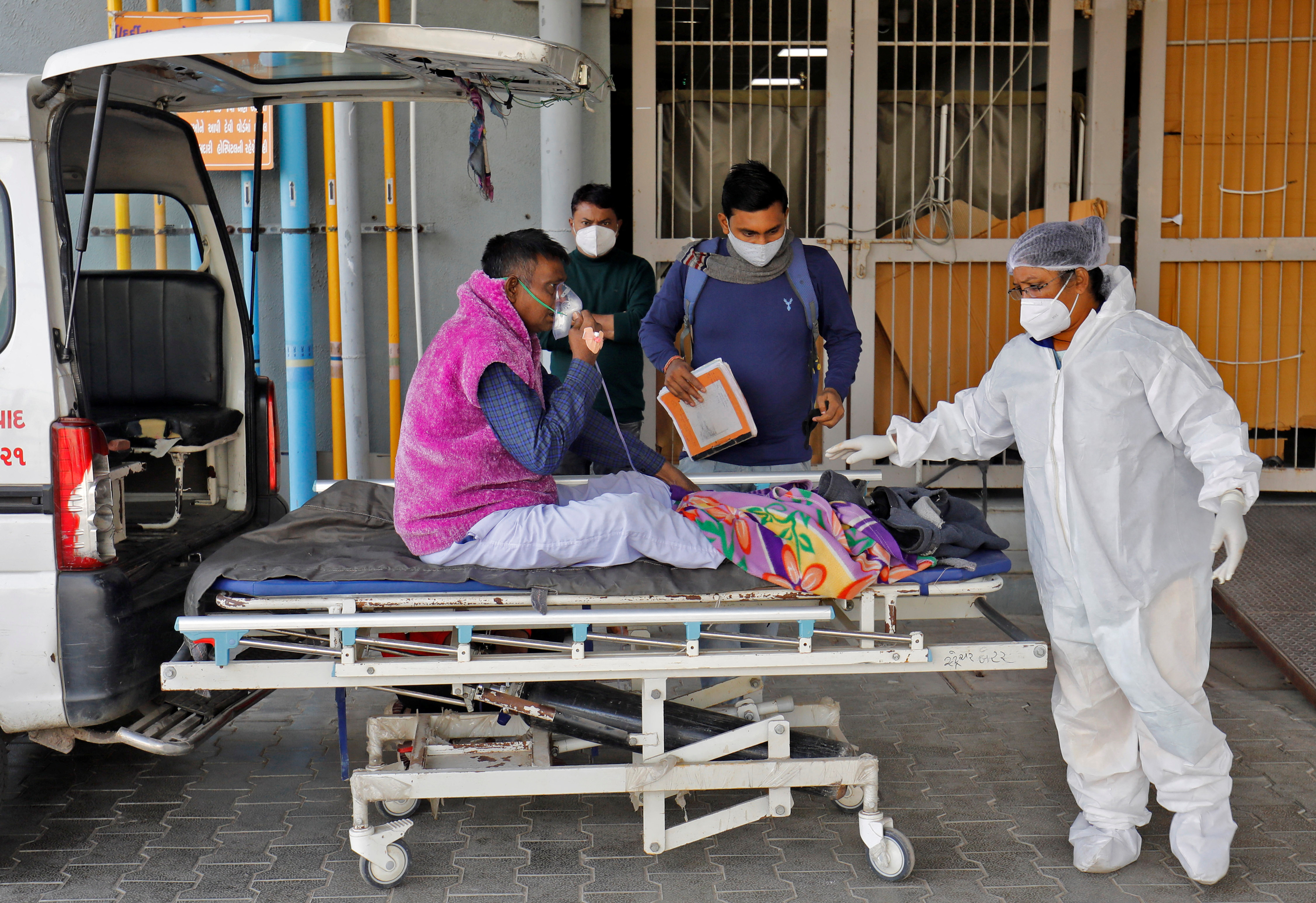 A man with breathing problem is wheeled inside a COVID-19 hospital for treatment during the ongoing coronavirus disease (COVID-19) in Ahmedabad