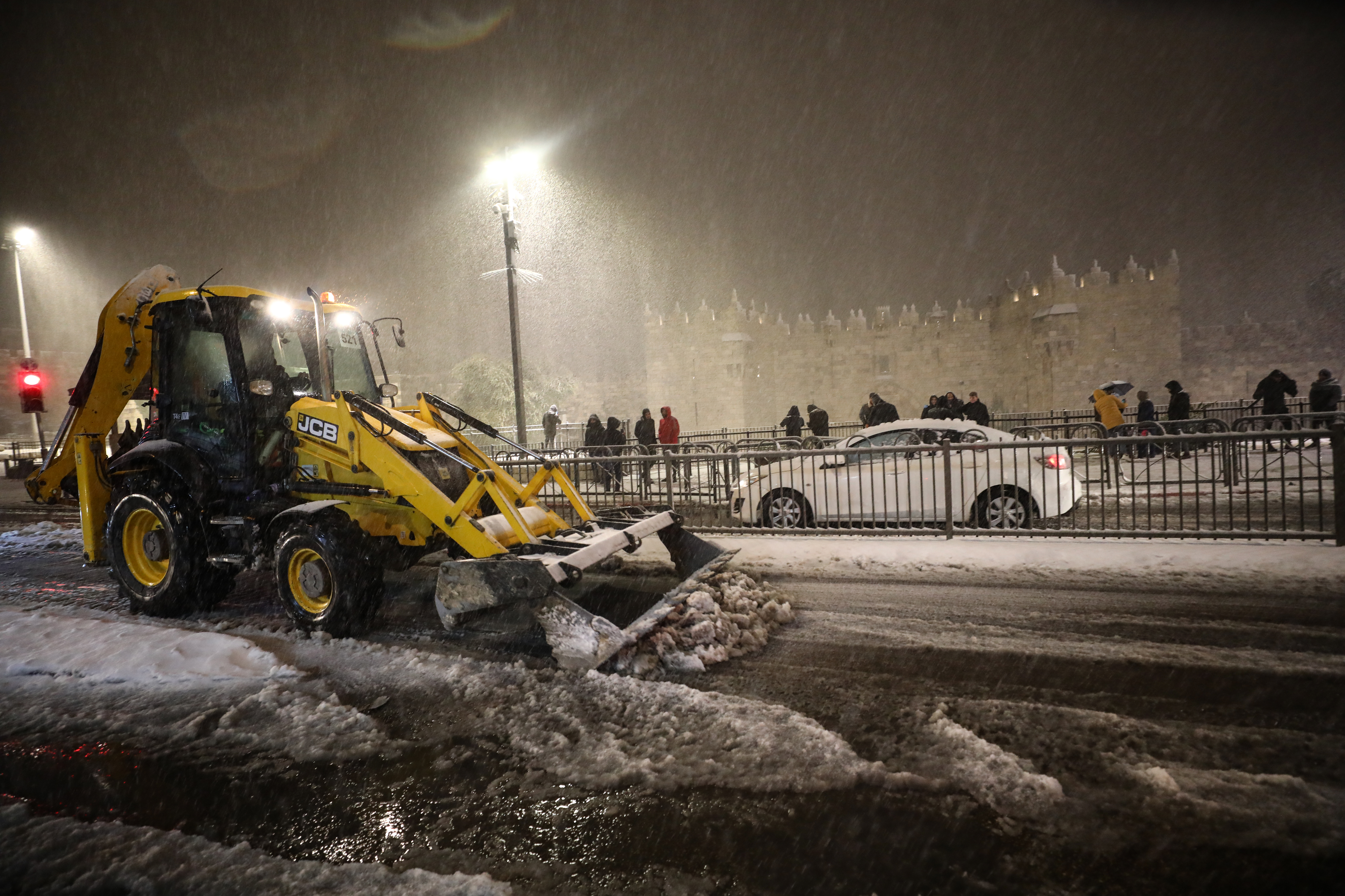 People gathering around Damascus Gate enjoy snow after snowfall in East Jerusalem on January 26, 2022. ( Mostafa Alkharouf - Anadolu Agency )