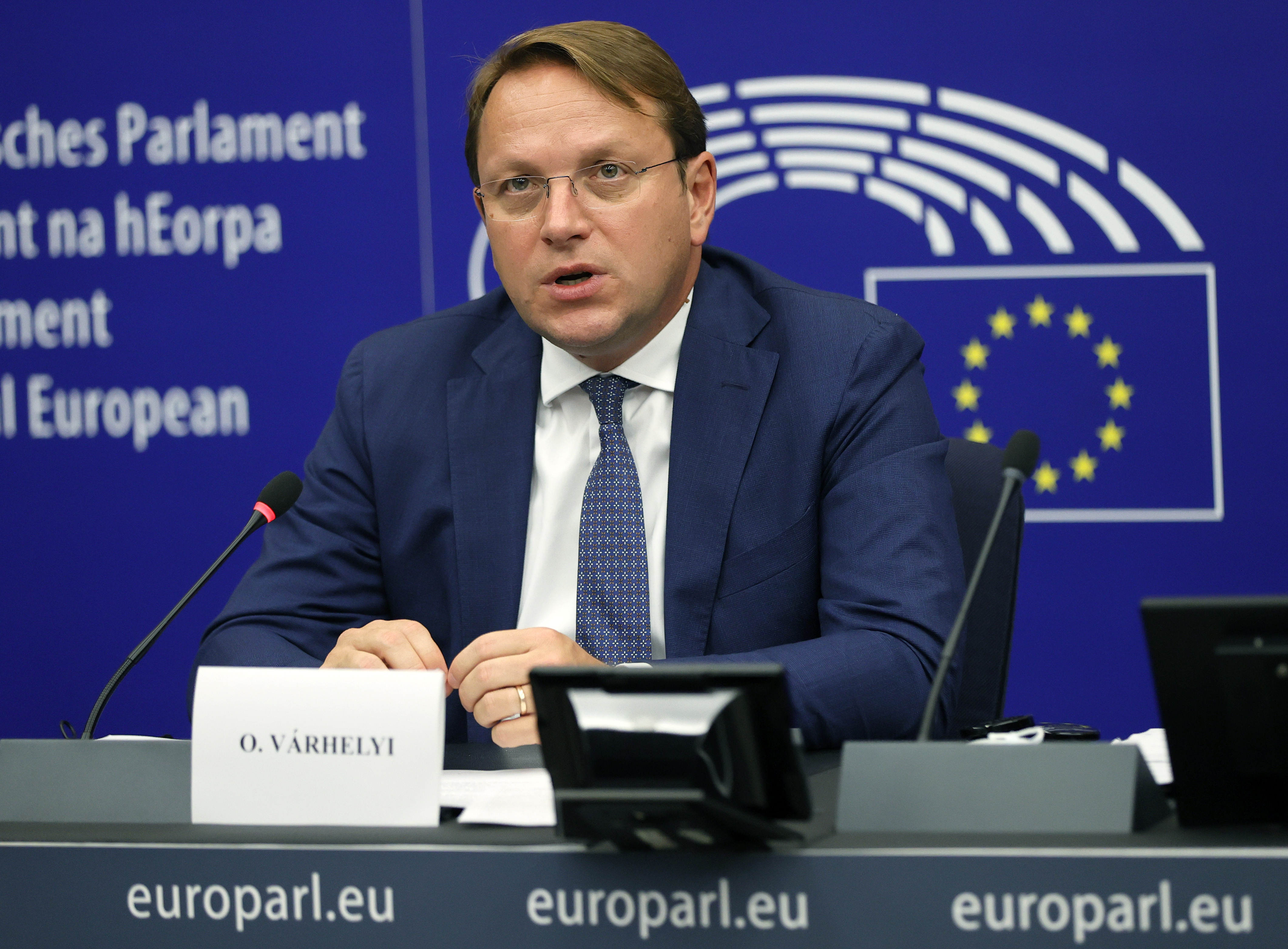European Commissioner for Neighbourhood and Enlargement Oliver Varhelyi is seen talking from his desk at a press conference