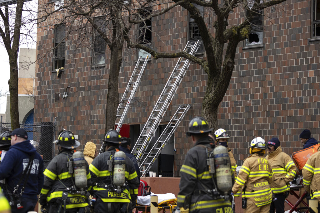 Ladders erected beside the apartment building where a fire occurred