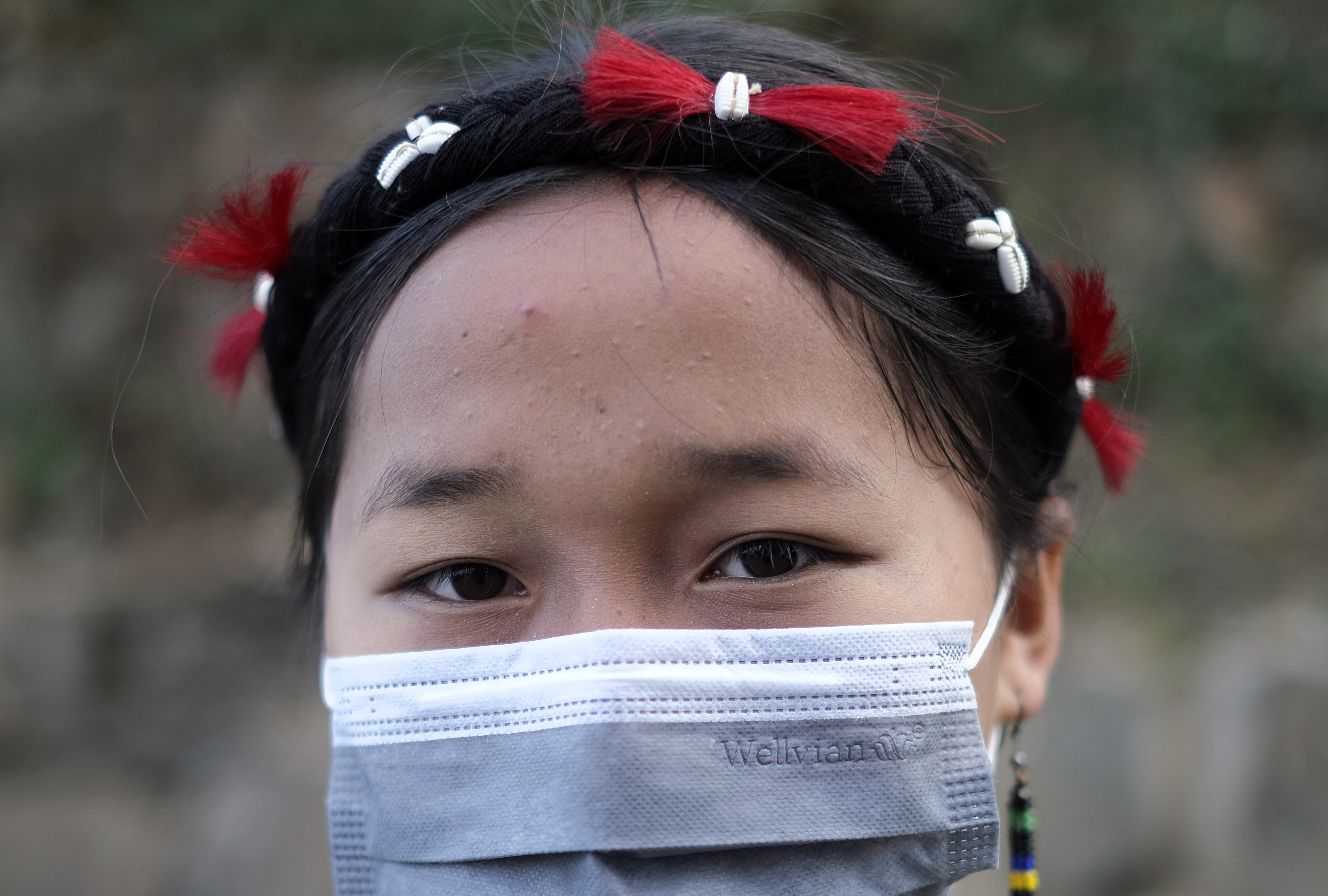 A Naga Woman at the protest with a mask