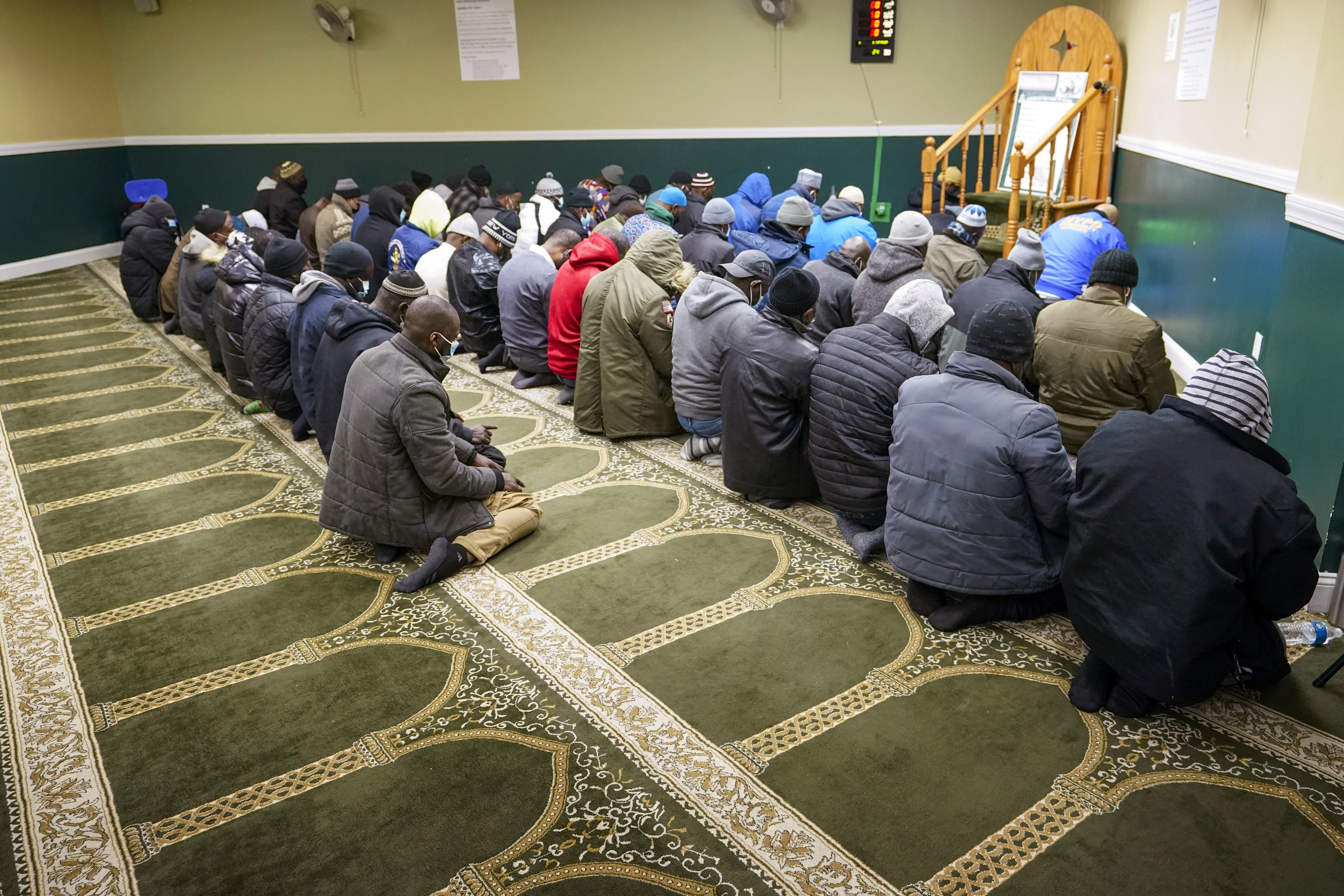 People pray at a mosque in the Bronx, near where an apartment fire killed 17