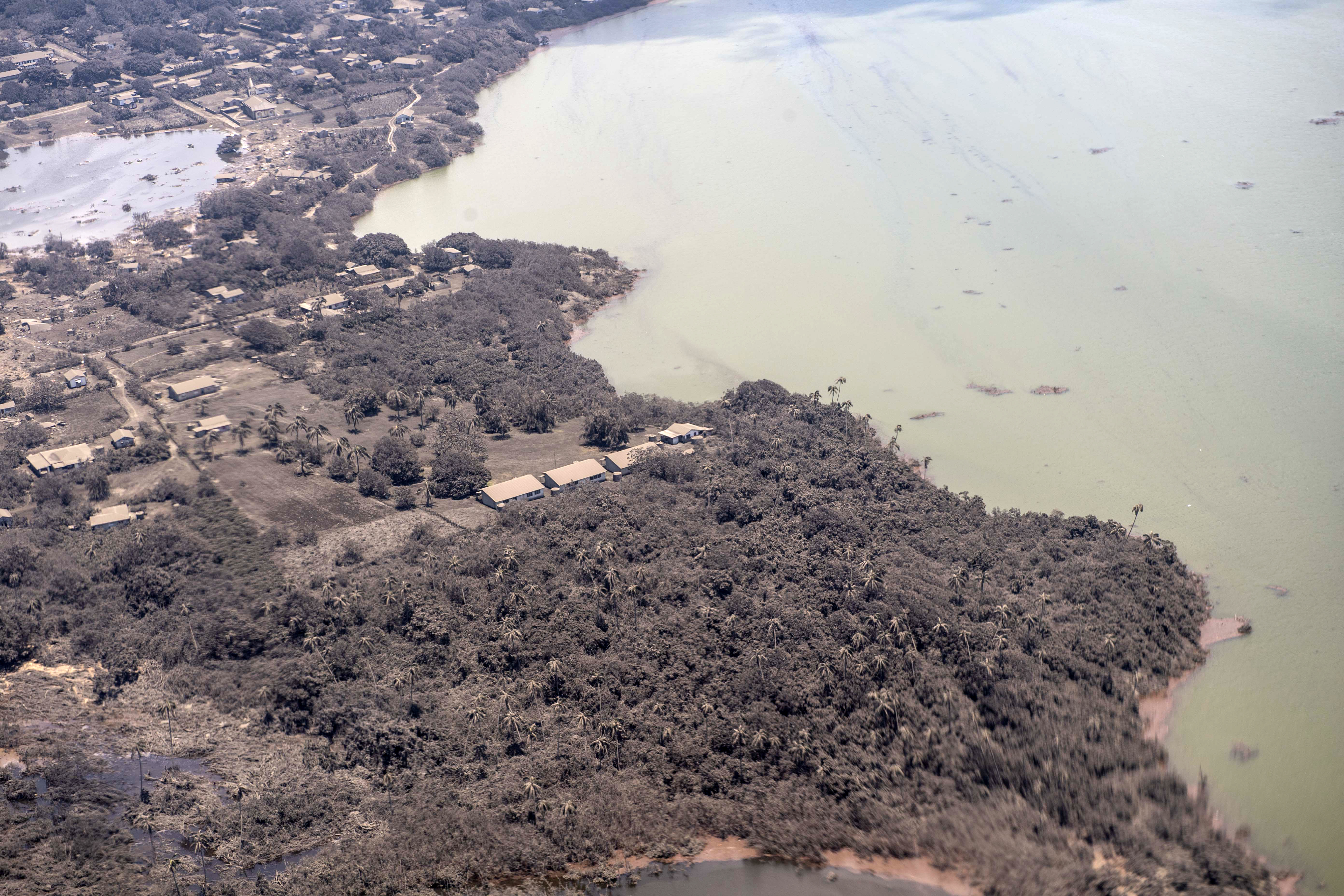 Ash covered homes and vegetation over Nomuka in Tonga