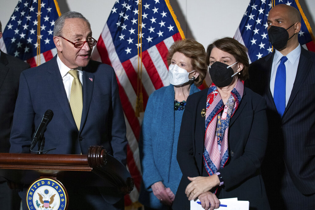 From left, Senate Majority Leader Chuck Schumer, D-N.Y., Sen. Debbie Stabenow, D-Mich., Sen. Amy Klobuchar, D-Minn., and Sen. Cory Booker, D-N.J., attend a press conference regarding the Democratic party's shift to focus on voting rights