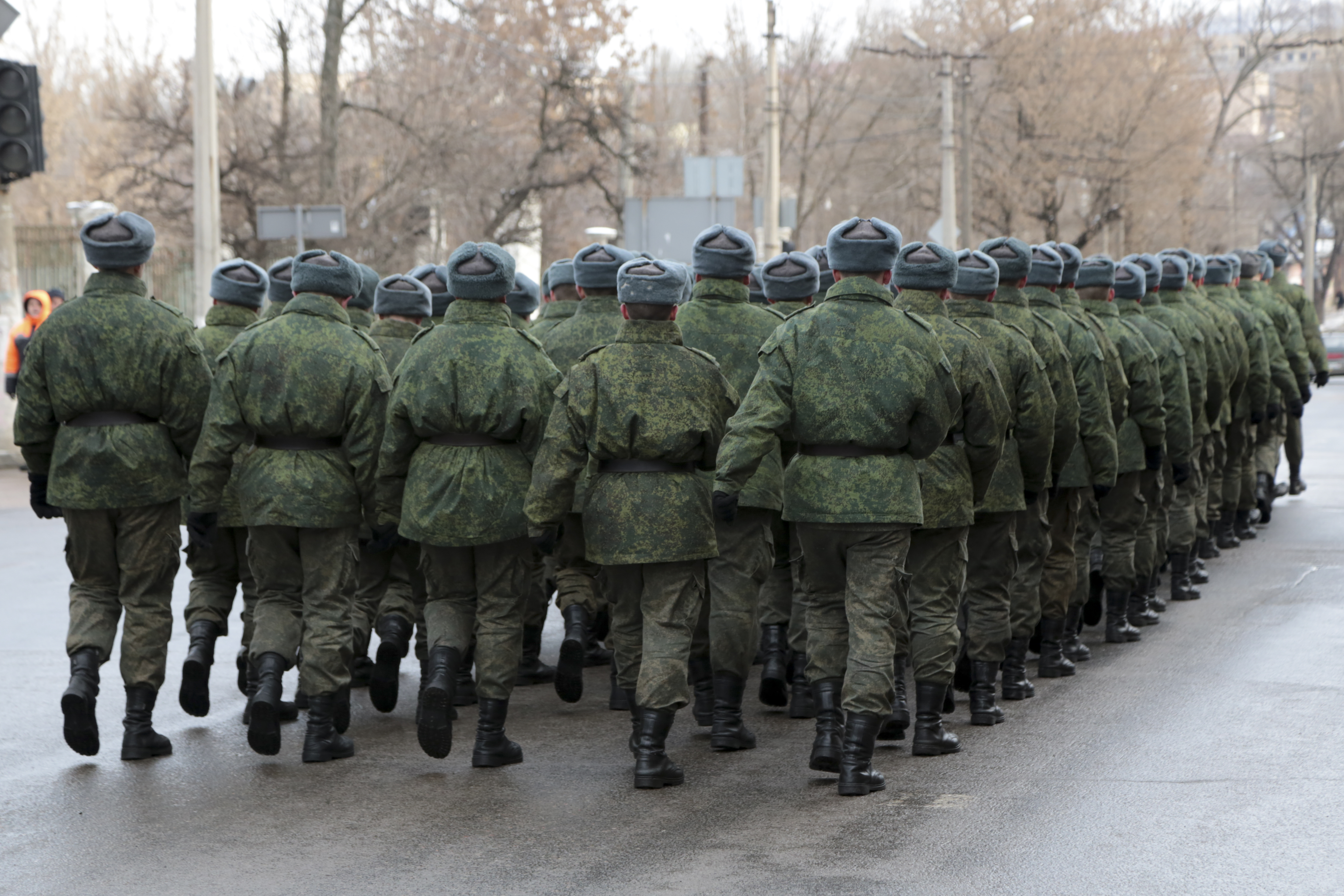 Servicemen march leaving a memorial ceremony to honor the memory of civilians who died during shelling at a crowded bus stop in 2015, in Donetsk