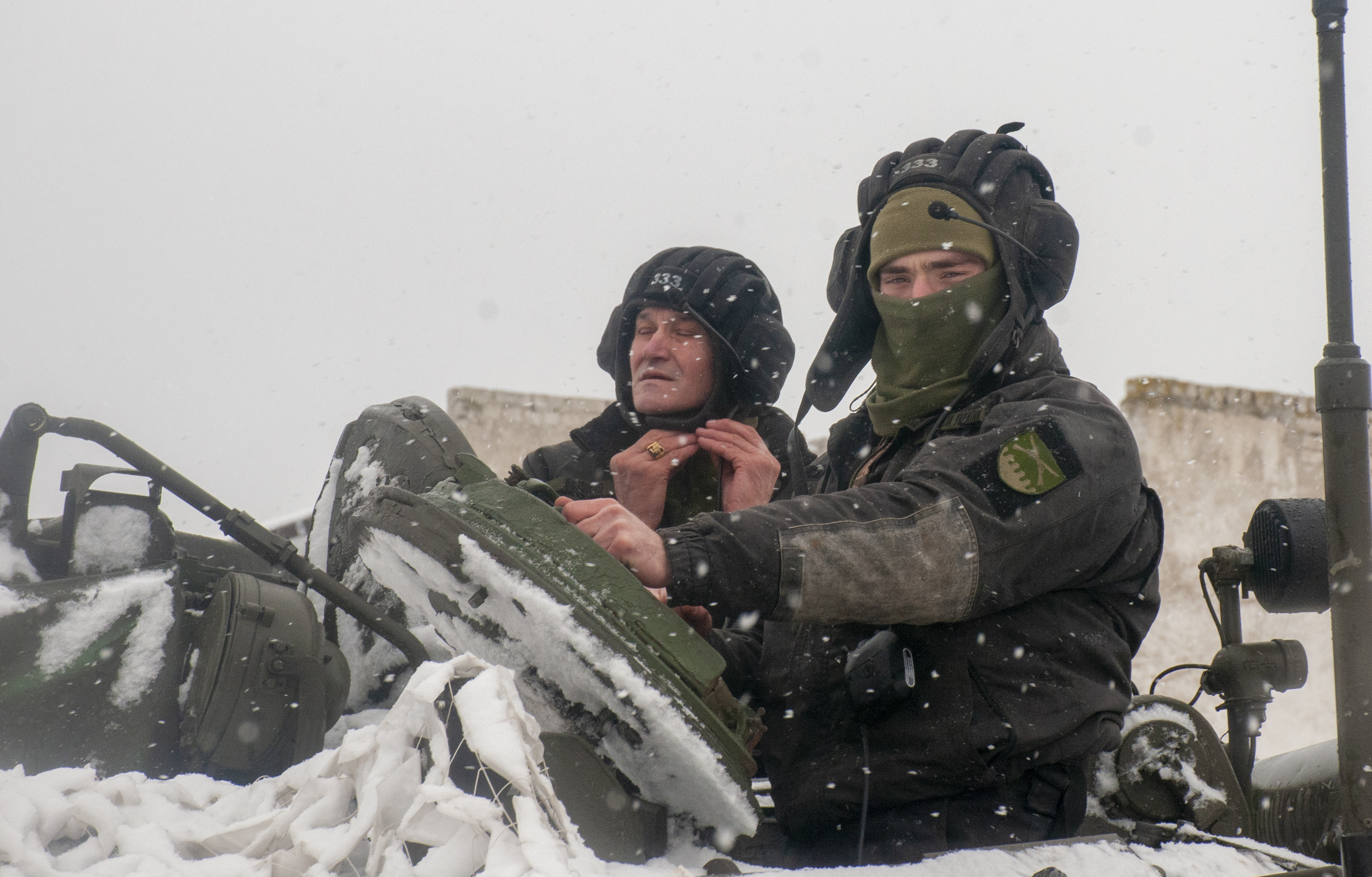 Ukrainian soldiers examine their tank at a military unit close to Kharkiv