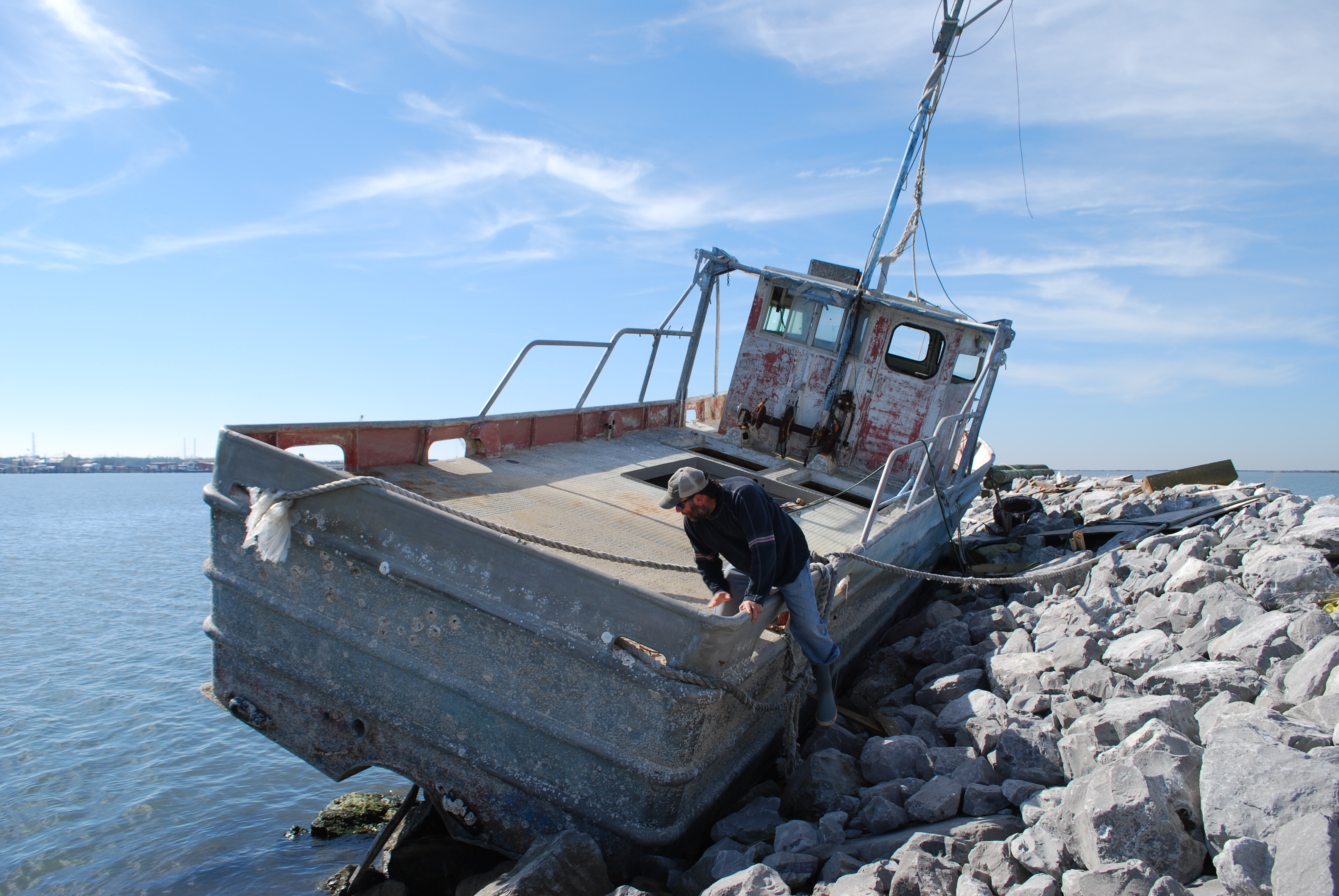Maurer climbs onto a stranded boat outside Grand Isle.
